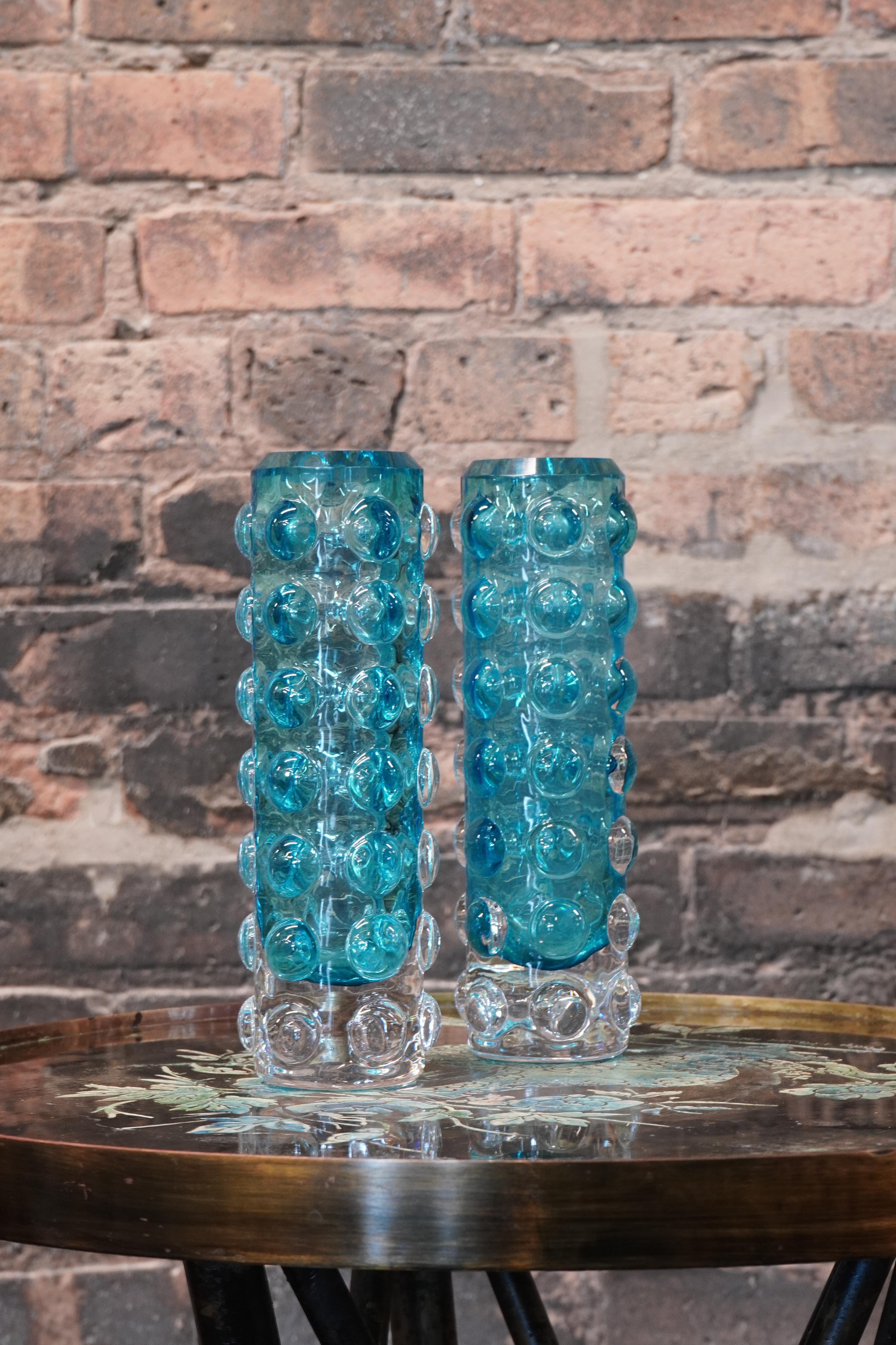 Lovely and heavy bubble glass vases attributed to Skruf of Sweden.  The vases are in good condition.  They have minimal light scratches to the bottom of each vase (see close up images).   No chips.  Lovely shade of light blue - leans toward