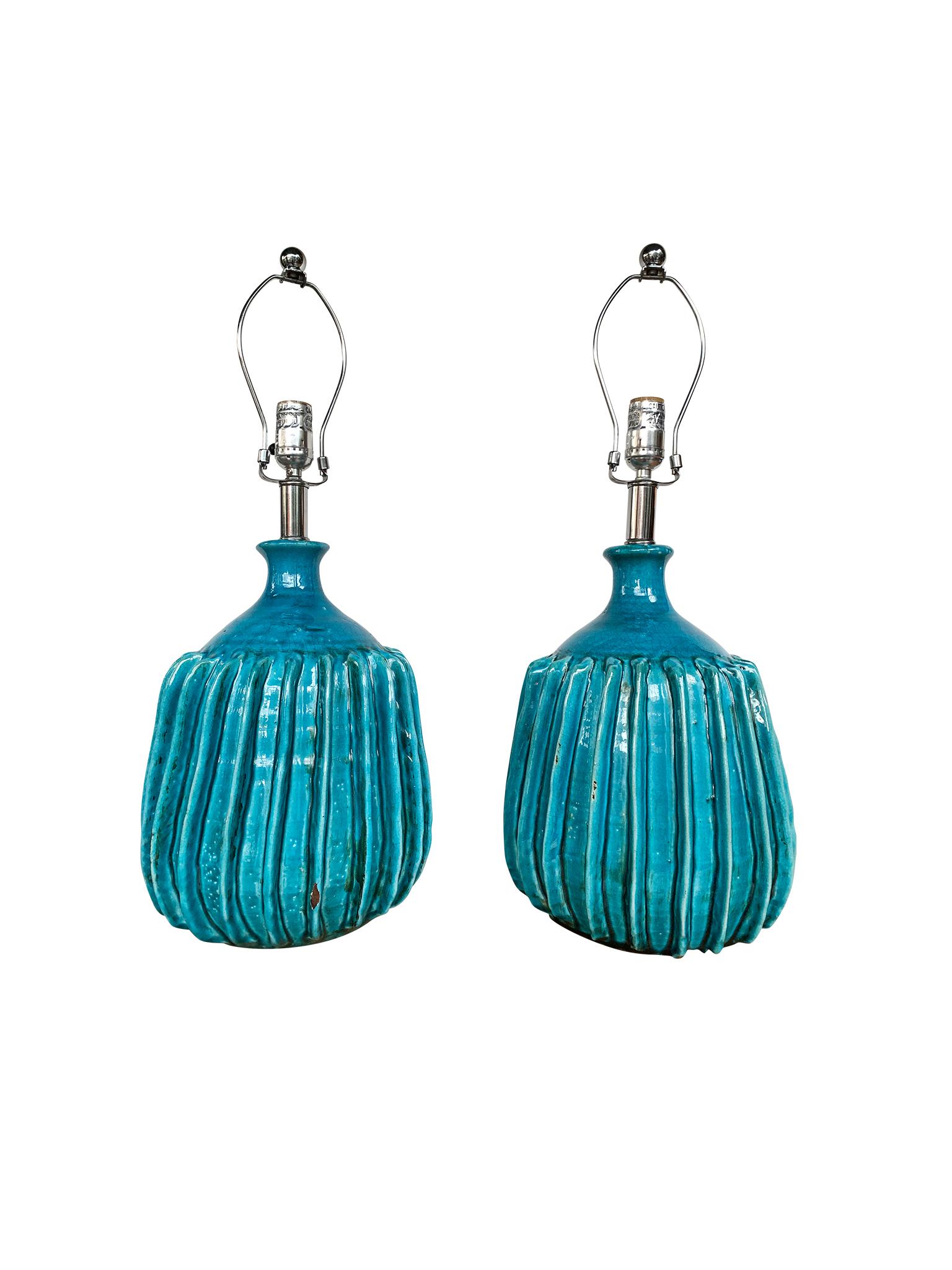 We love these spectacular table lamps! They will enrich your home not only with their lighting but also with their rich turquoise color, crackle glaze, and ridged texture. The lamps are ceramic with chrome hardware. They're paired with burlap