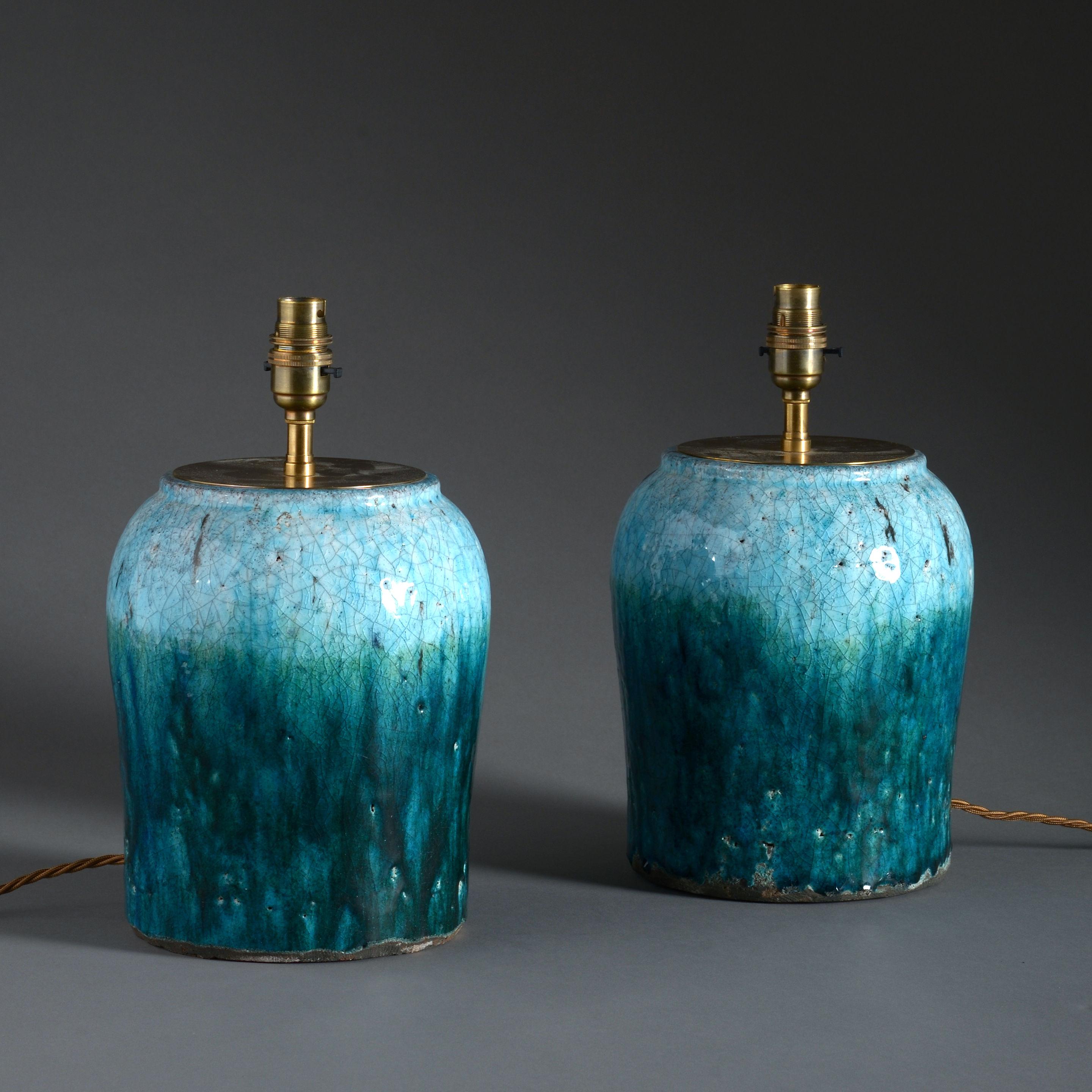 A pair of Studio Pottery art vases, with variegated crackle glazes of green turquoise and green. Now mounted as a pair of table lamps.