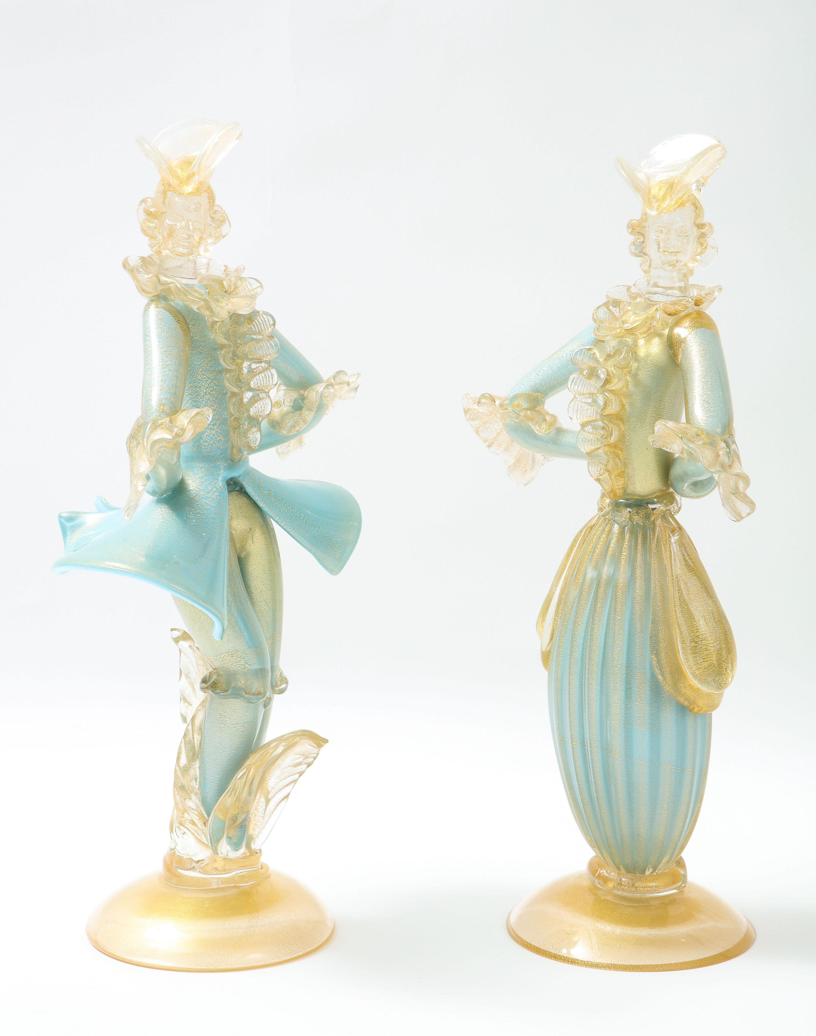 Pair of turquoise Murano glass costume figurines in the Louis XV style with ruffles by Seguso Vetri Arte with gold leaf circular base.