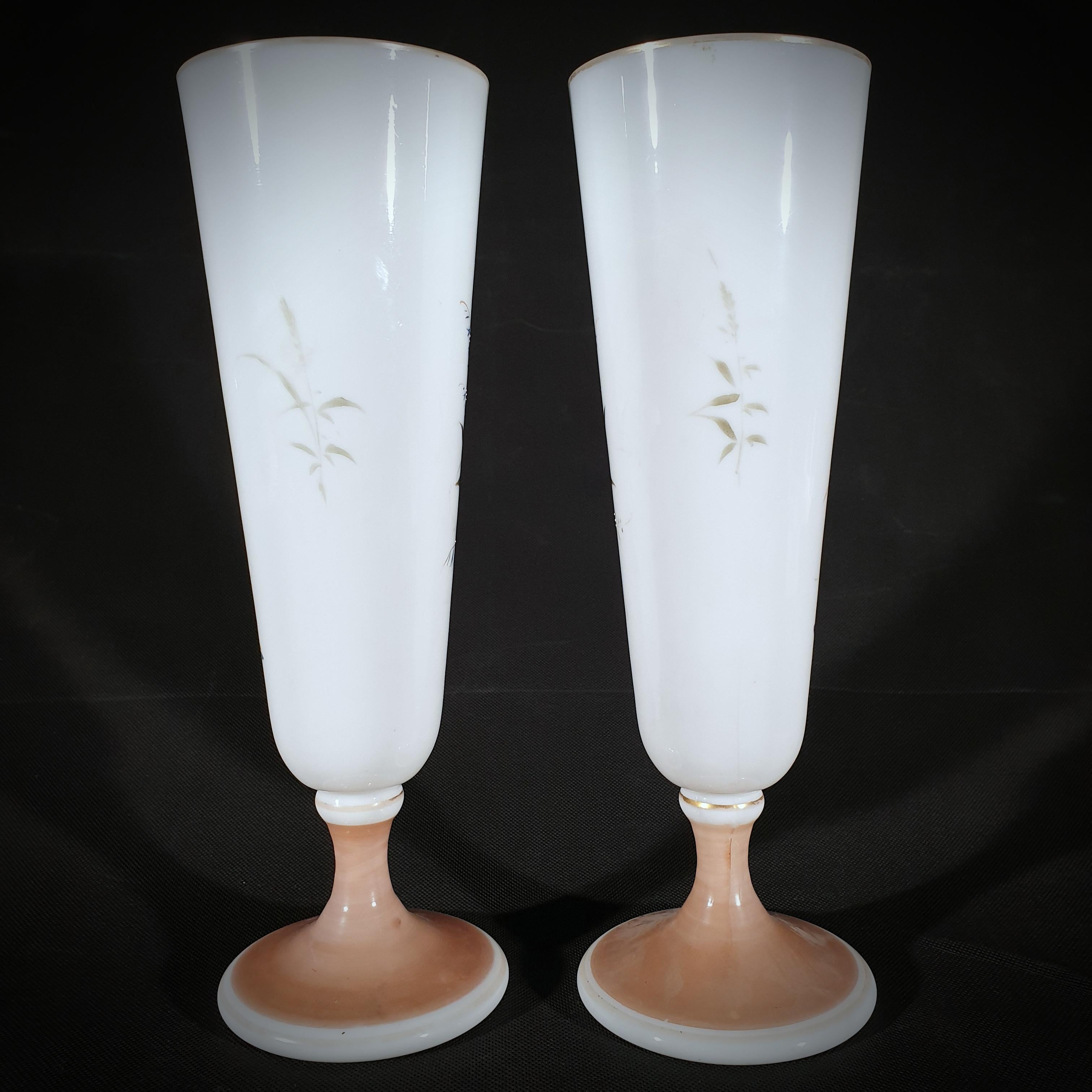 Pair of white opaline vases. Decorated with beautiful hand-painted flowers and butterflies. gilded around the base and the rim.
This elegant pair was made in France from approximately 1850 to 1920.
The pair is in perfect condition, with no chips or