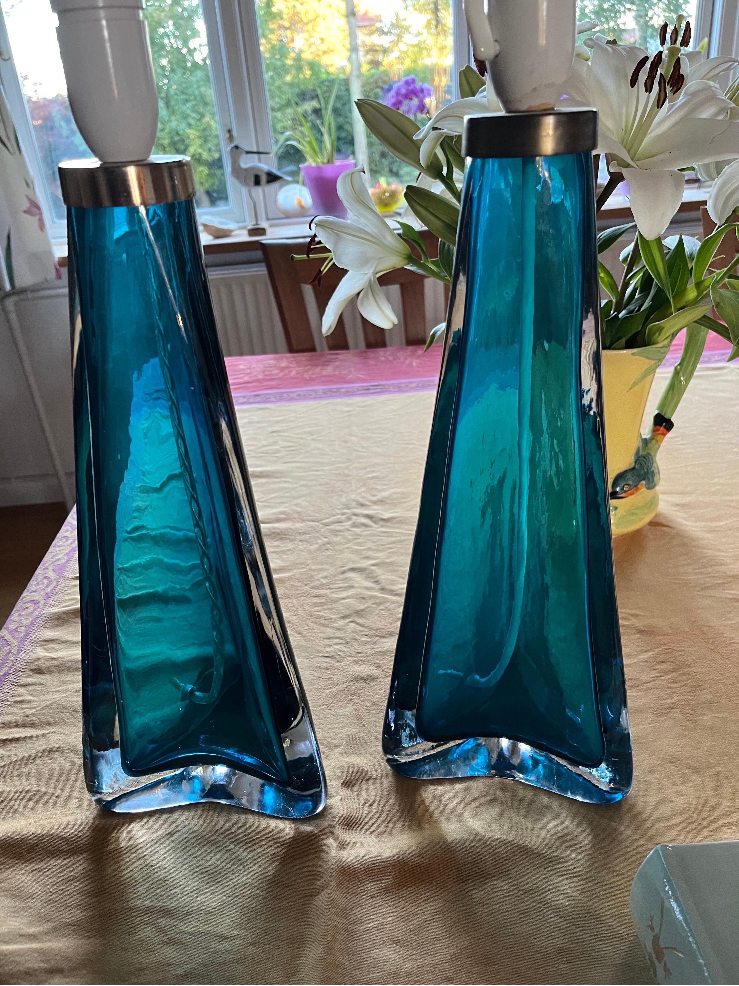 Pair of Caribbean turquoise ocean blue triangular Orrefors lamps, Sweden, 1960 encased in a layer of clear glass with brass fittings, by Carl Fagerlund for Orrefors, 1960.
Highest quality of crystal glass each lamp is very heavy and with a shade