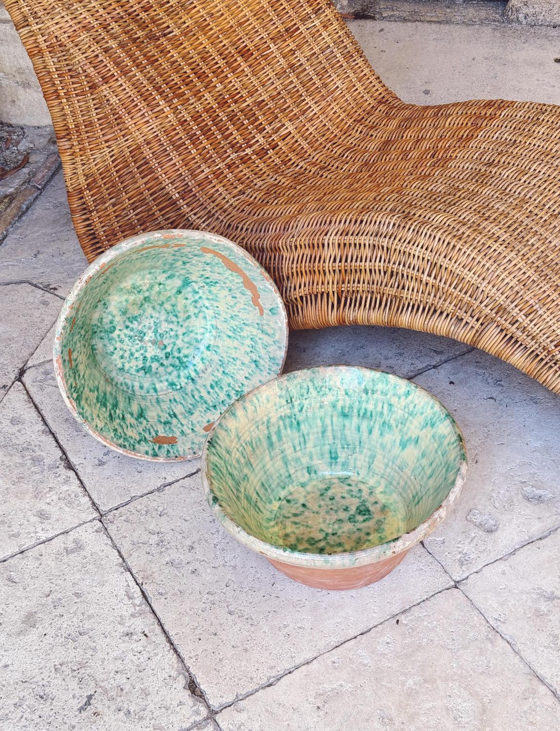 Set of Two Tuscan bowls made in the early 1900s. Both are glazed with turquoise and white speckles on the inside, leaving the external terracotta on display. One bowl has a more intact glaze than the other a more gentle. These bowls had a variety of