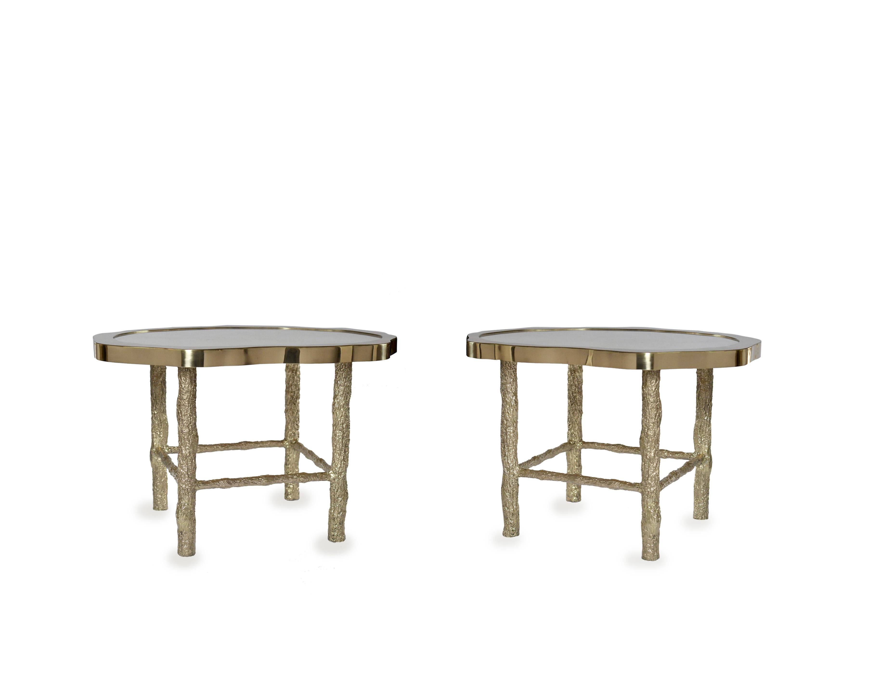 Pair of rock crystal quartz cocktail tables with twig inspired hammered brass legs, created by Phoenix Gallery.
Custom size upon request