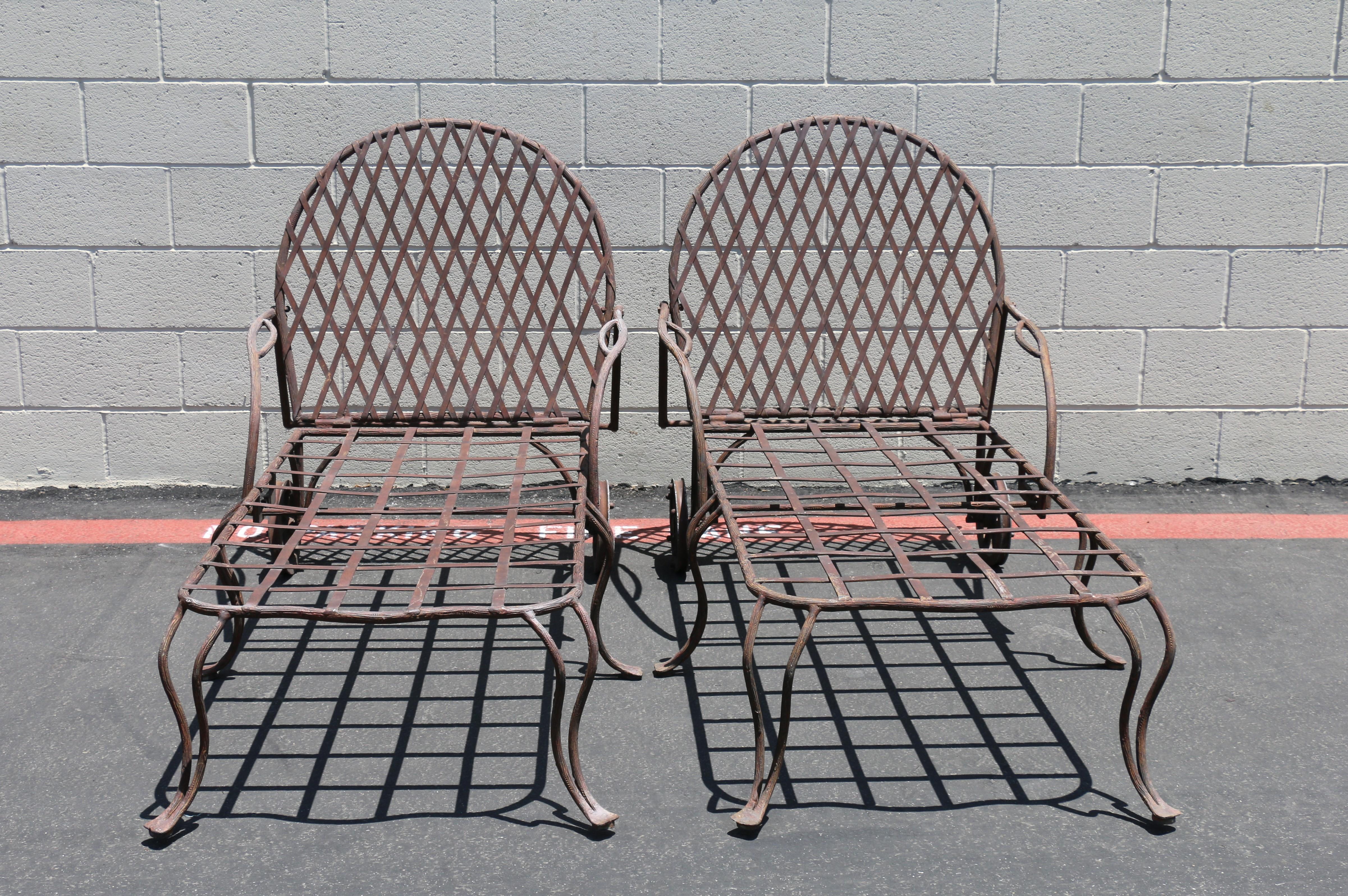 Pair of wrought iron outdoor chaise lounge designed by Rose Tarlow Melrose House. These pair of chaise lounge features a large faux bois twig motif iron frame with geometrical lattice inset. The iron has its original aged, patinated finish.