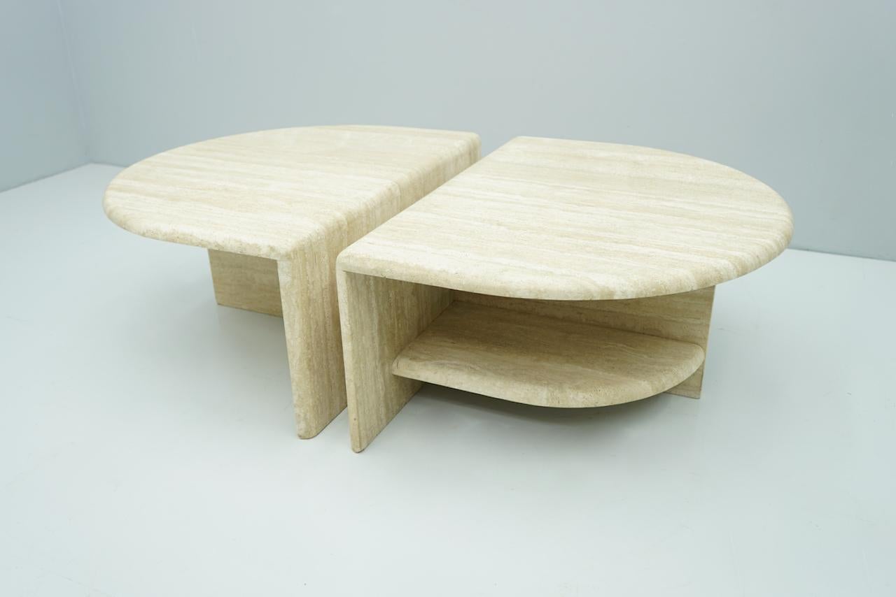 Pair of twin travertine coffee tables, 1970s. Can be used individually or together. 
Measurements per item: 
W 70 cm, D 90 cm, H 41 cm. Weight of each table: 90 Kilo.

Very good condition.