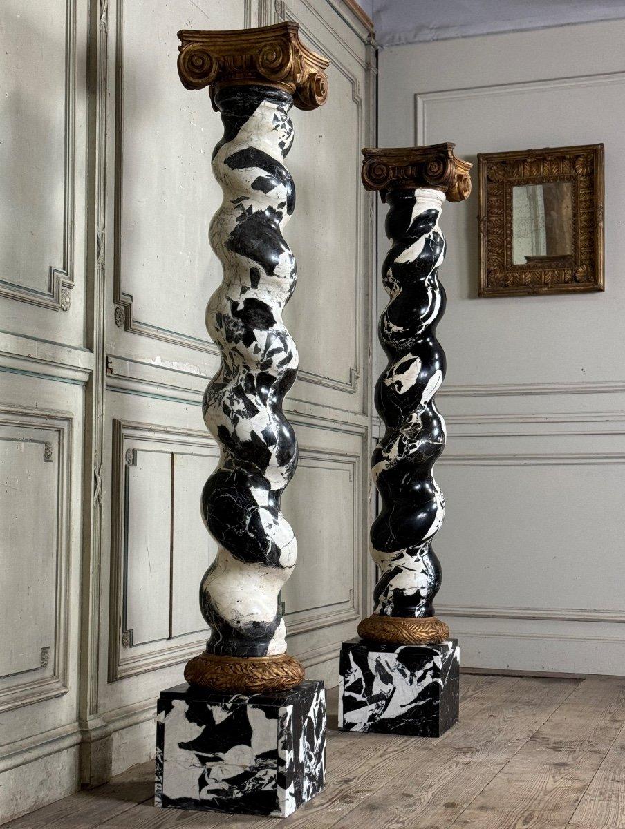 Pair of twisted columns in Grand Antique marble, capitals and bases in gilded plaster
