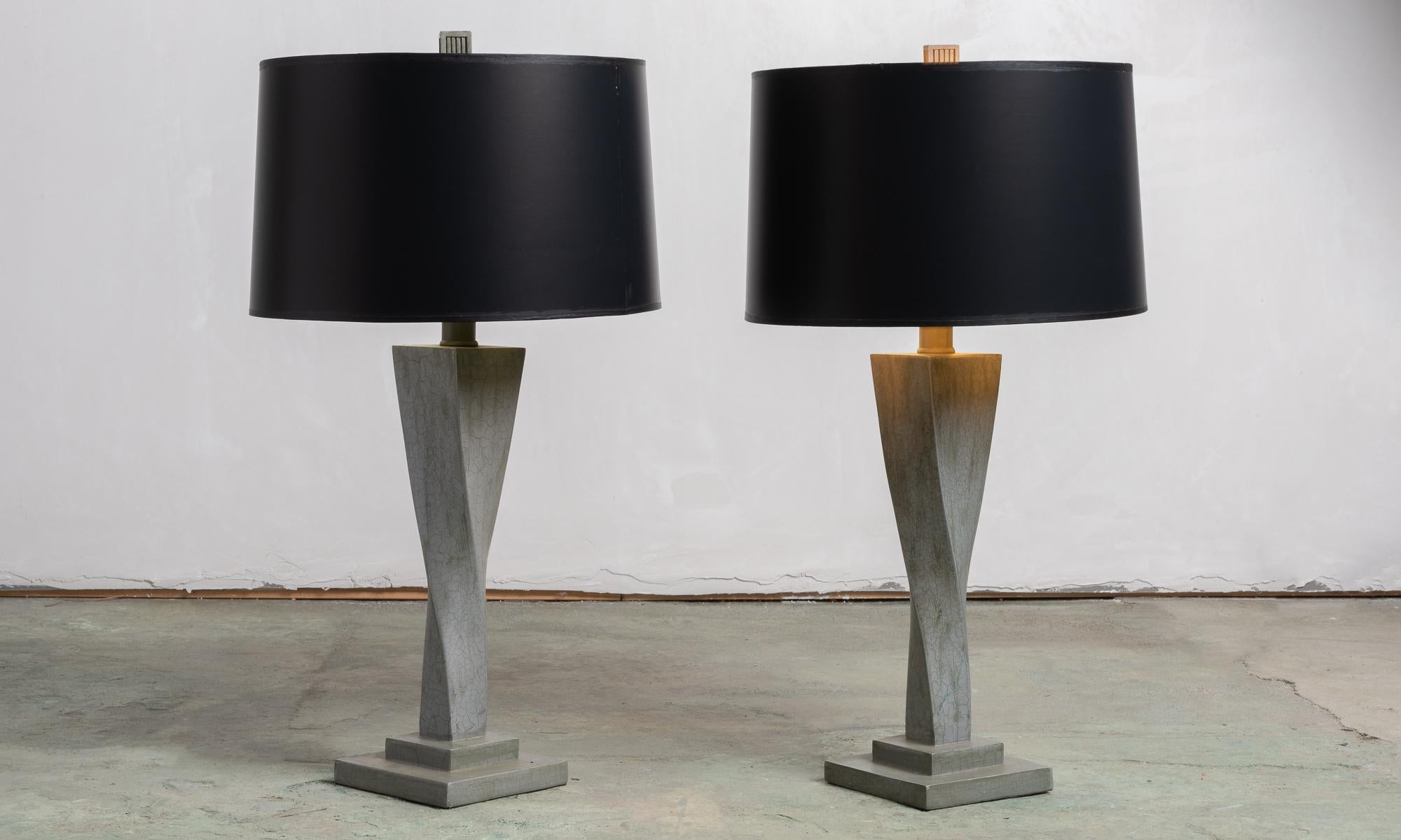 Pair of twisted grey ceramic table lamps, America, circa 1950.

Geometric twisting forms feature black shades with gilded interiors.