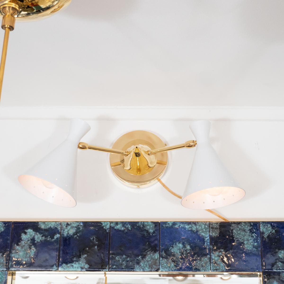 Pair of two-arm, spotlight sconces with articulated arms and enameled metal shades.