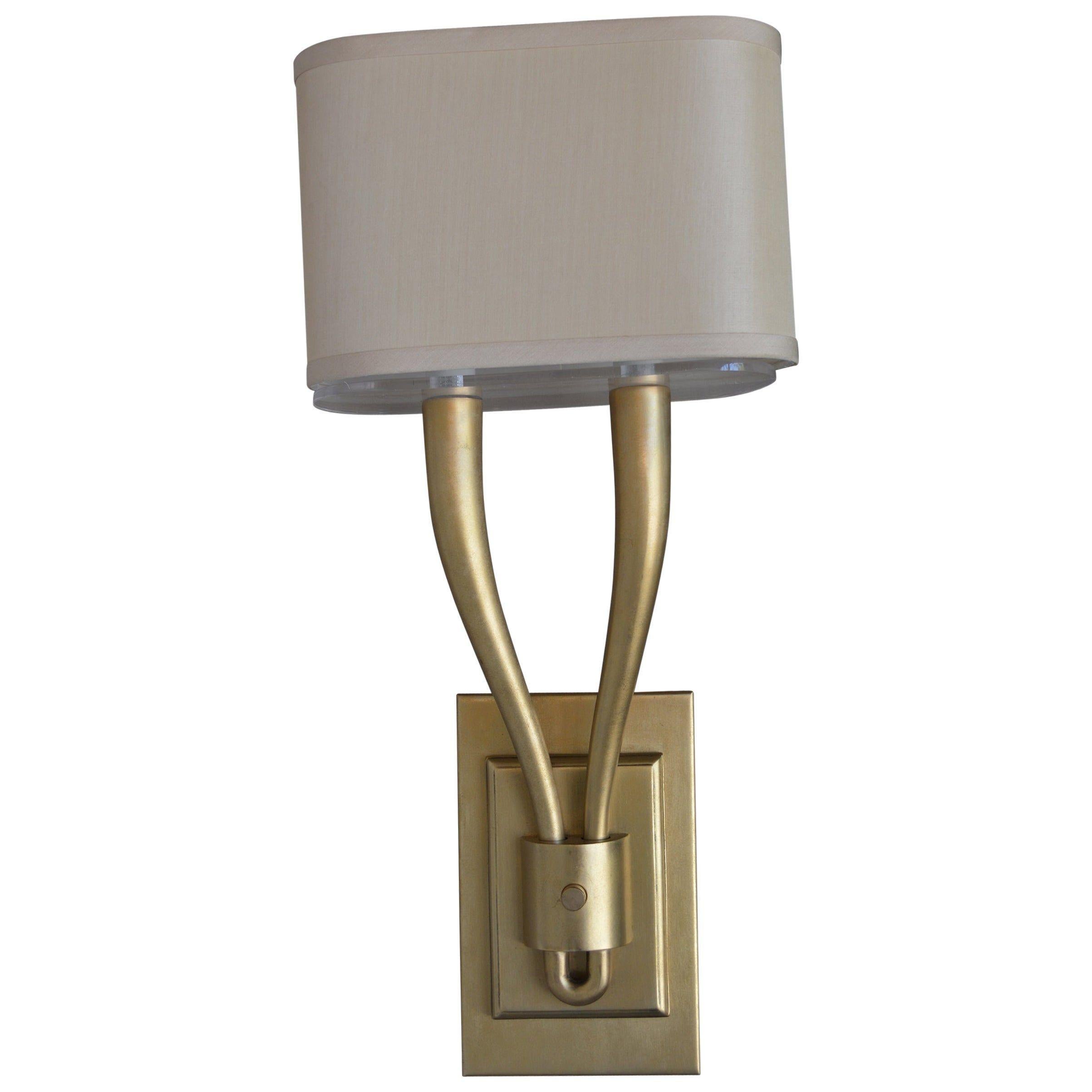 Two arm brushed brass sconces with shades.
