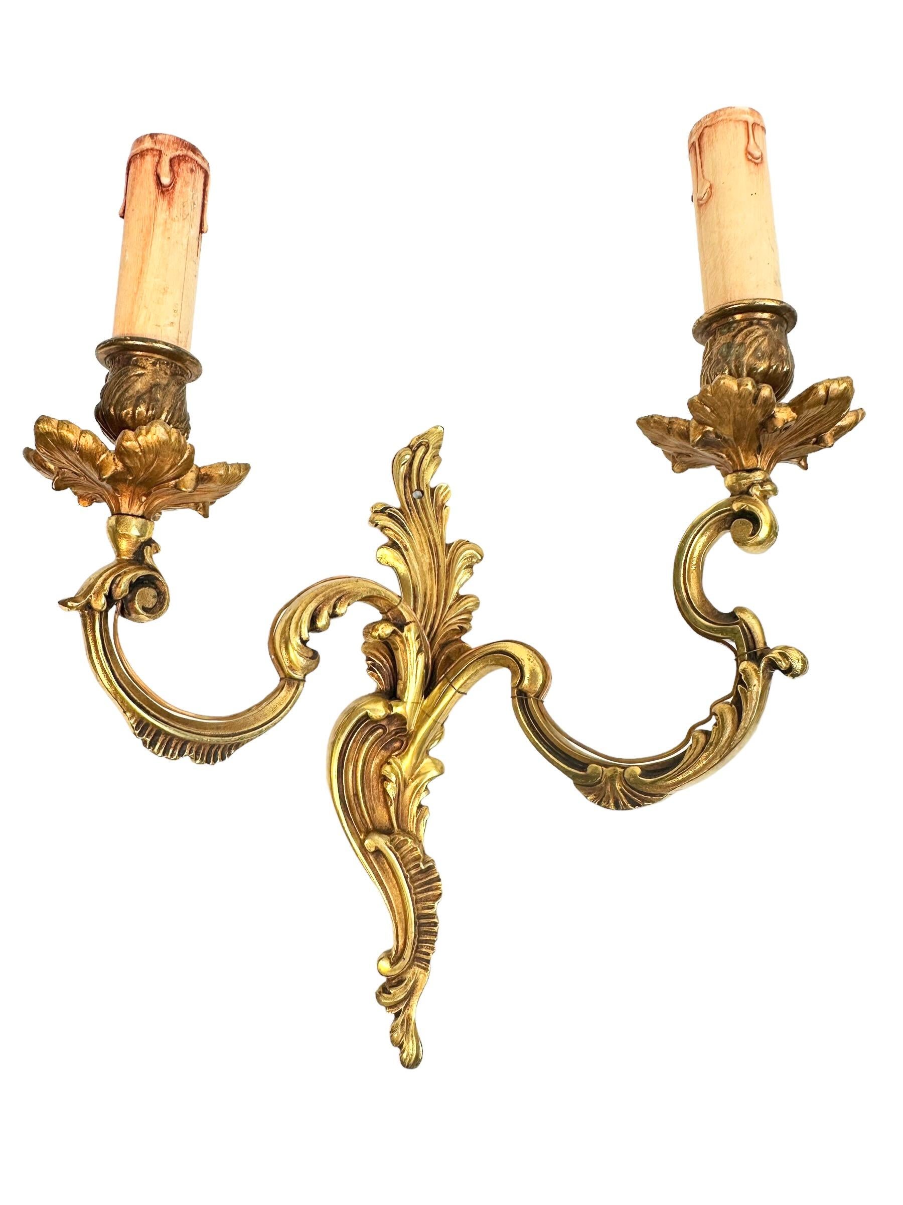 Pair of nice Sconces. Each fixture requires two European E14 candelabras bulbs, each bulb up to 40 watts. These wall lights have a beautiful patina and gives each room an eclectic statement. Made of bronze metal. Nice addition to any room. Found at