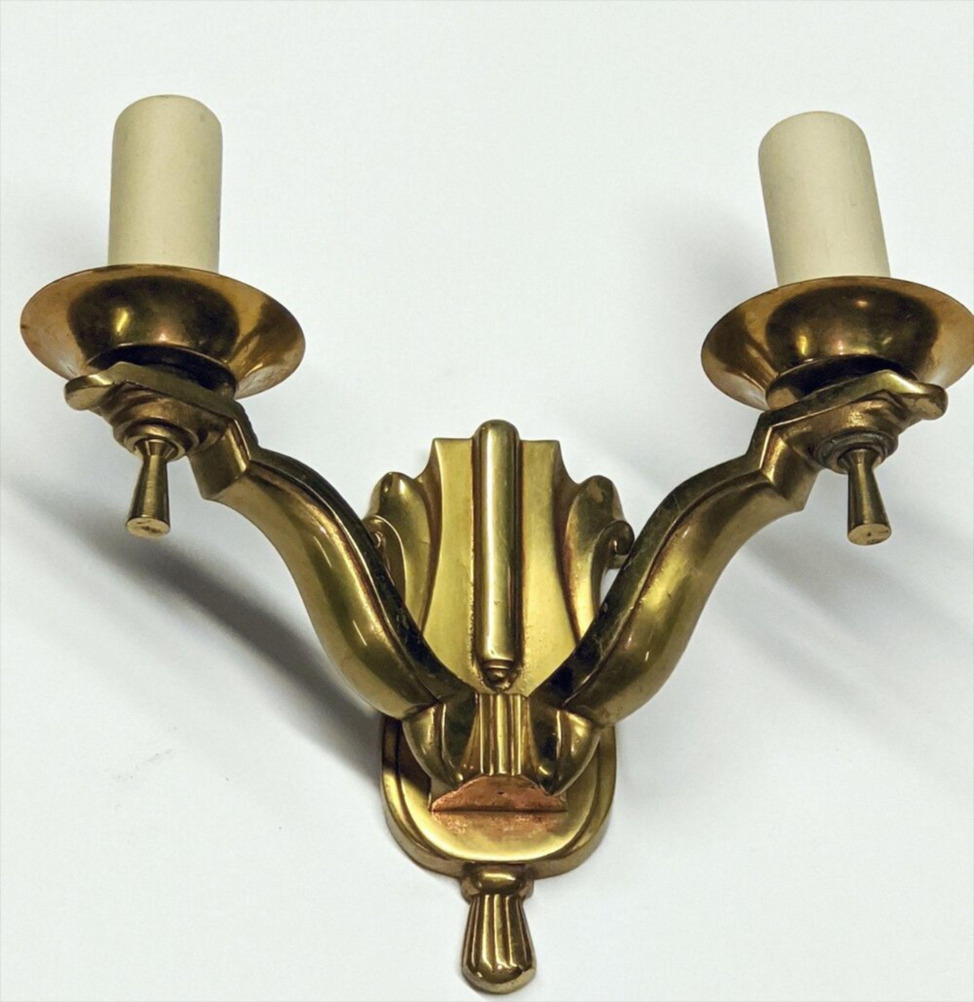 French Art Deco pair of bronze two-branch sconces in neoclassical style. Measures: 9” wide x 4” deep x 8” high. Designer: Unknown.