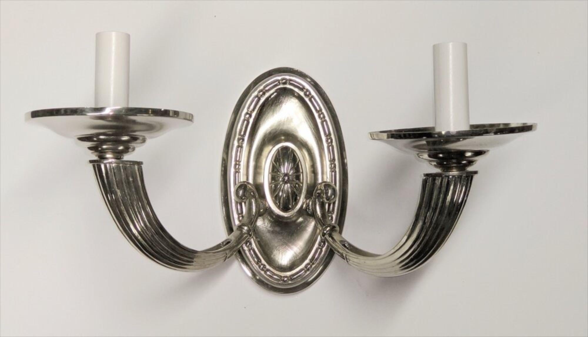 French Art Deco pair of two-branch silvered metal sconces. Designer unknown. Measures: 14” wide x 8” deep x 7” high.

  