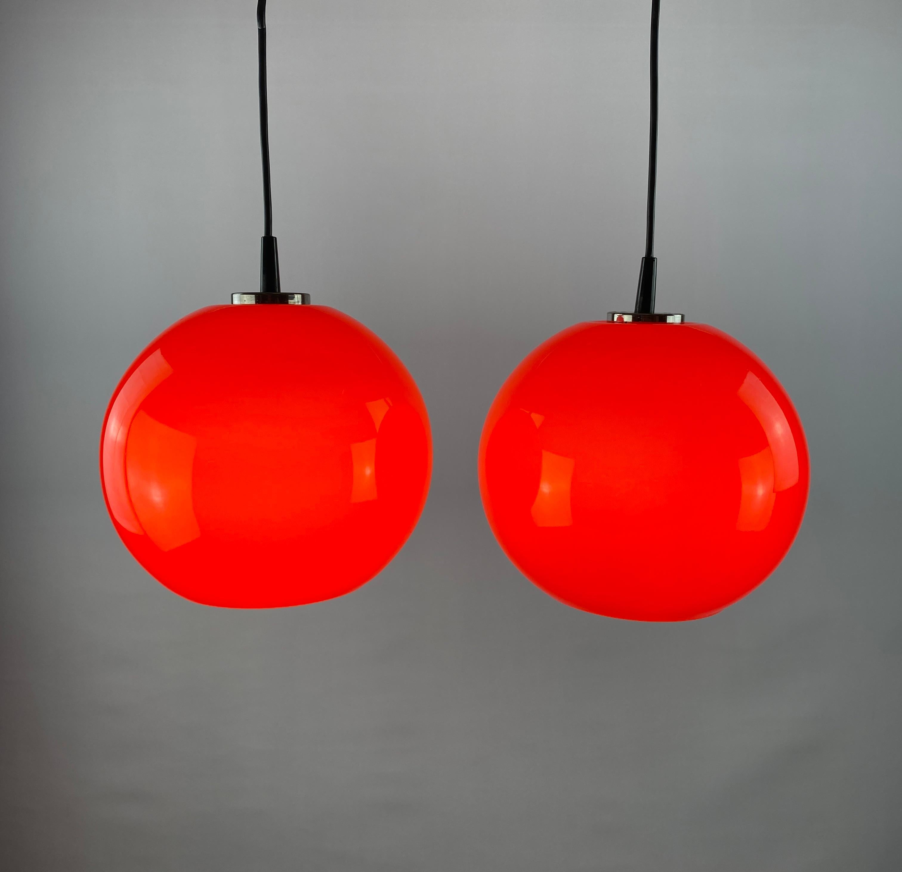 Set of two cherry colored pendant lights by Peill and Putzler from the 1970's. Provides a beautiful cherry-like light through the glass.

DIMENSIONS
Height: 22cm
Diameter: 23cm
Cord length: 20cm (can be made longer if desired)

PRODUCT