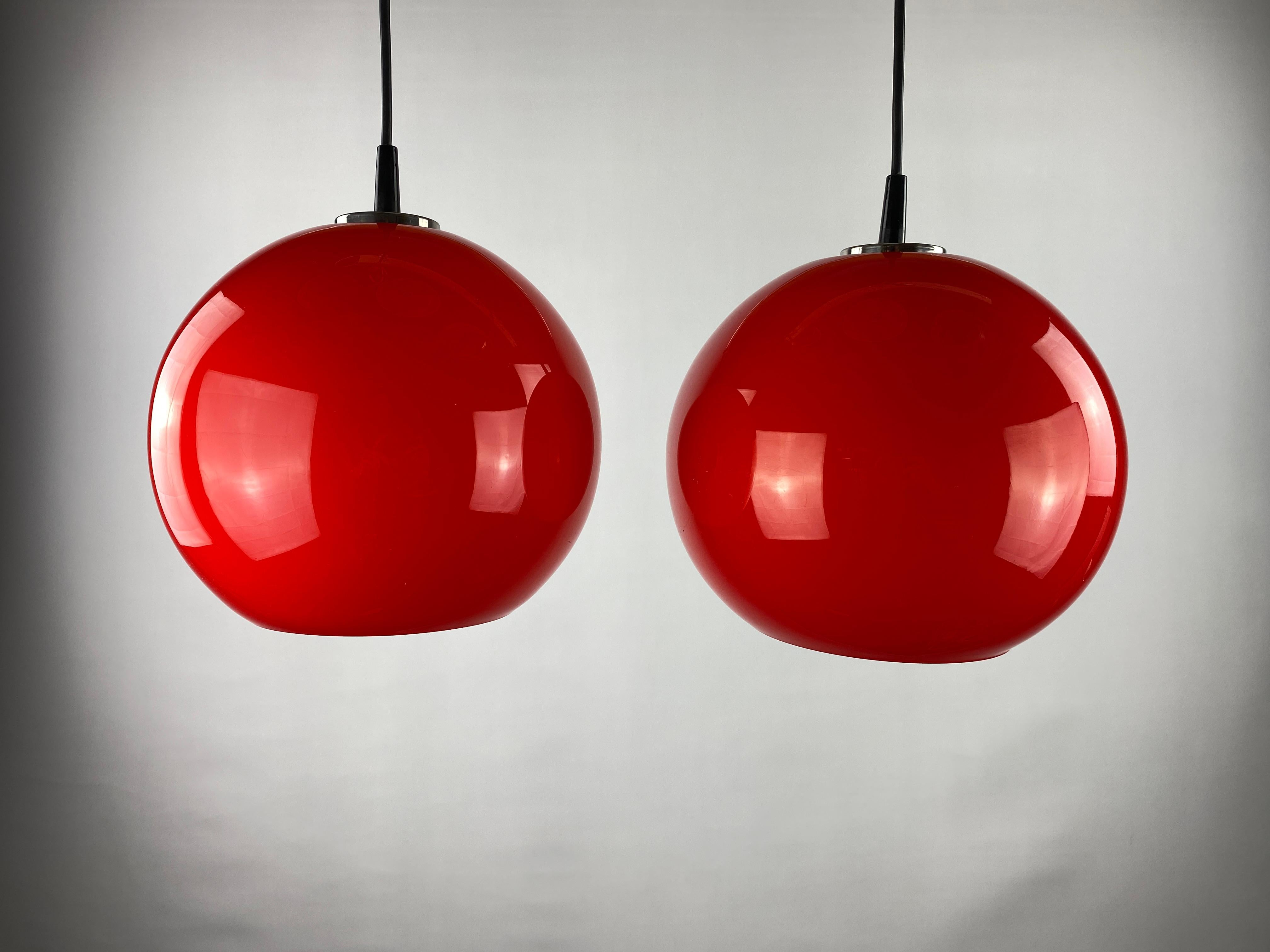 Glass Pair of two cherry red glass Peill & Putzler pendant lights, 1960 For Sale