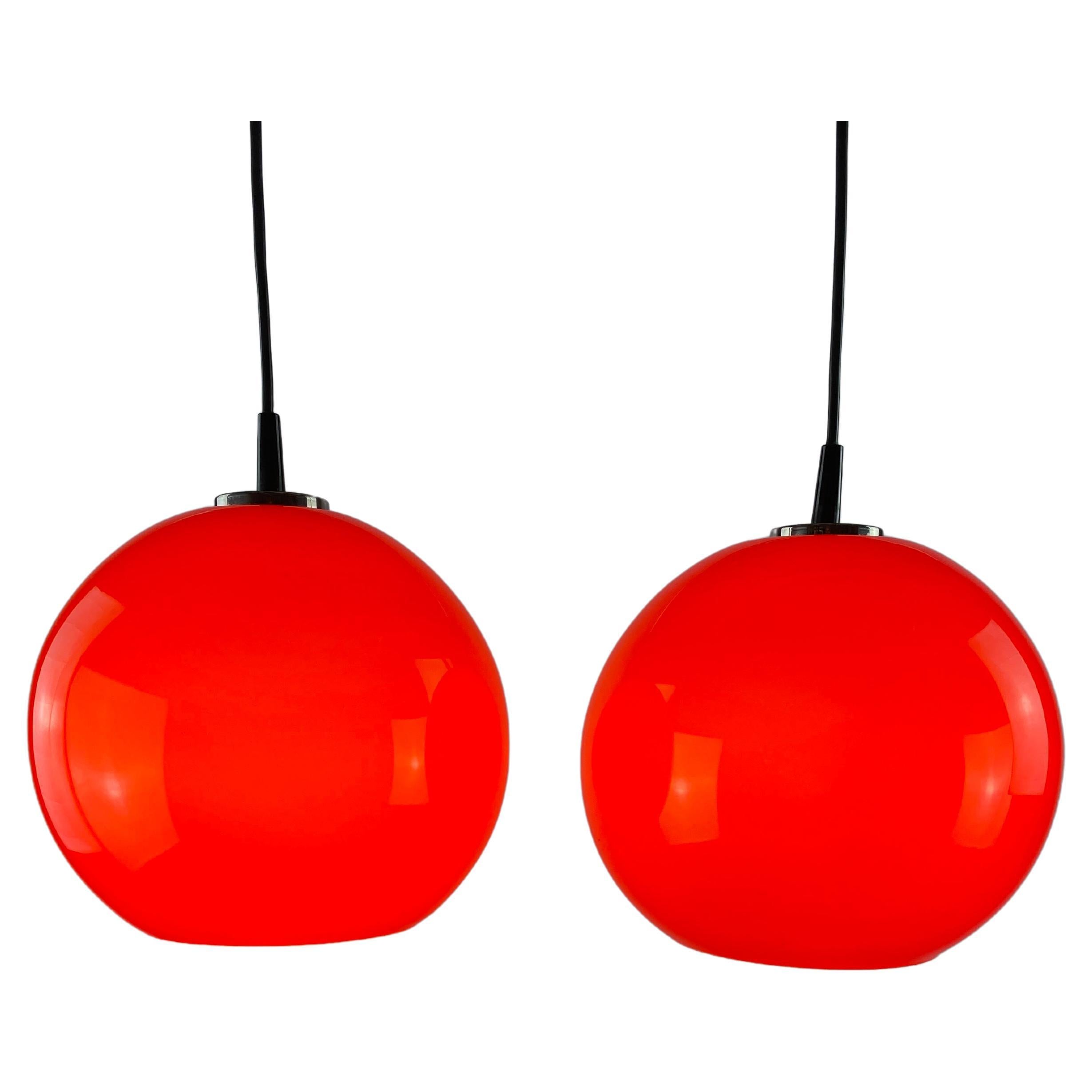 Pair of two cherry red glass Peill & Putzler pendant lights, 1960 For Sale