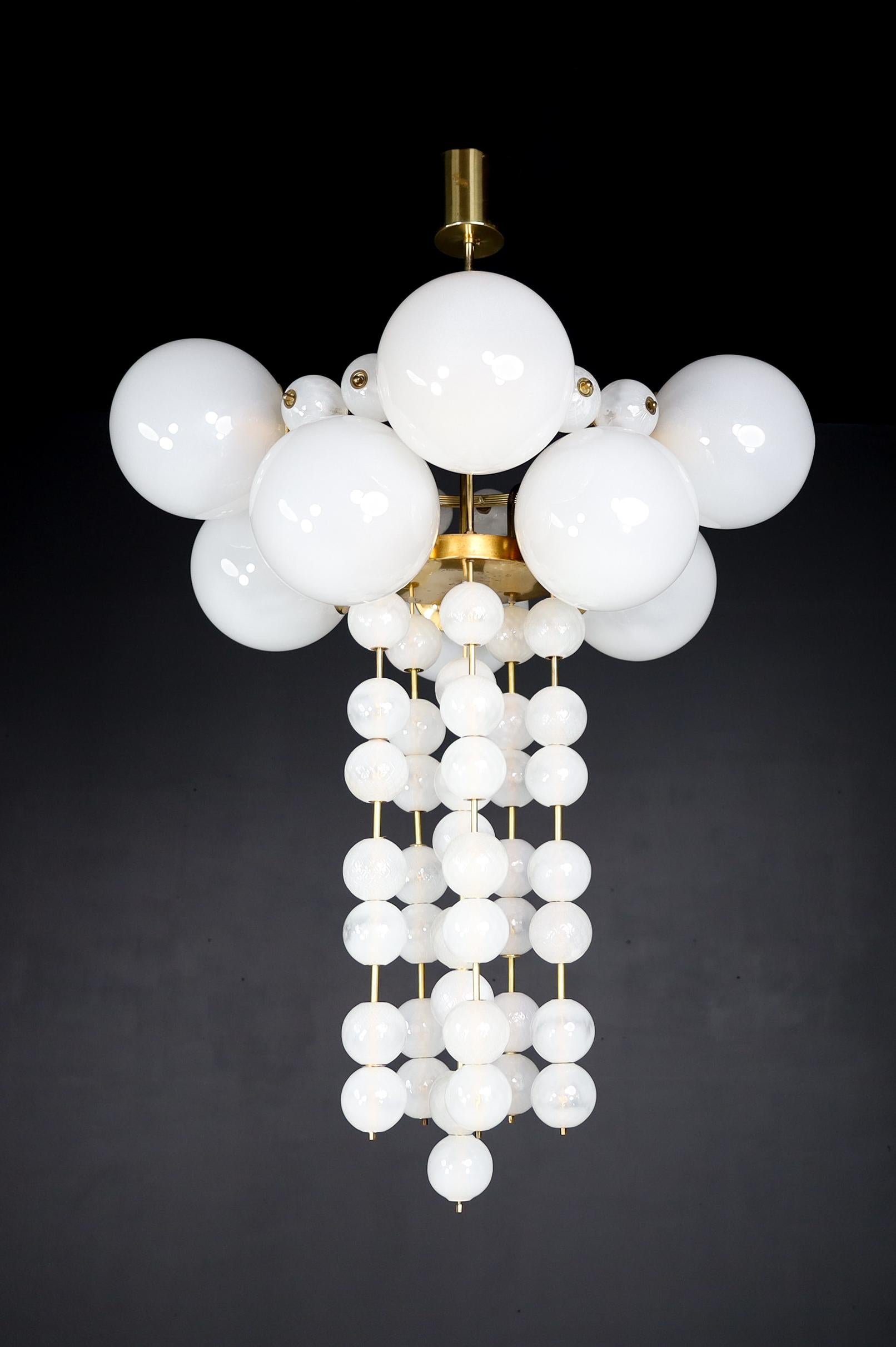 Pair of two Grand Bohemian chandeliers with brass fixtures and hand-blowed frosted glass globes, Czechia 1960s

A pair of two large Bohemian chandeliers with a brass fixture was produced and designed in Czechia in the 1960s. A total of ten large