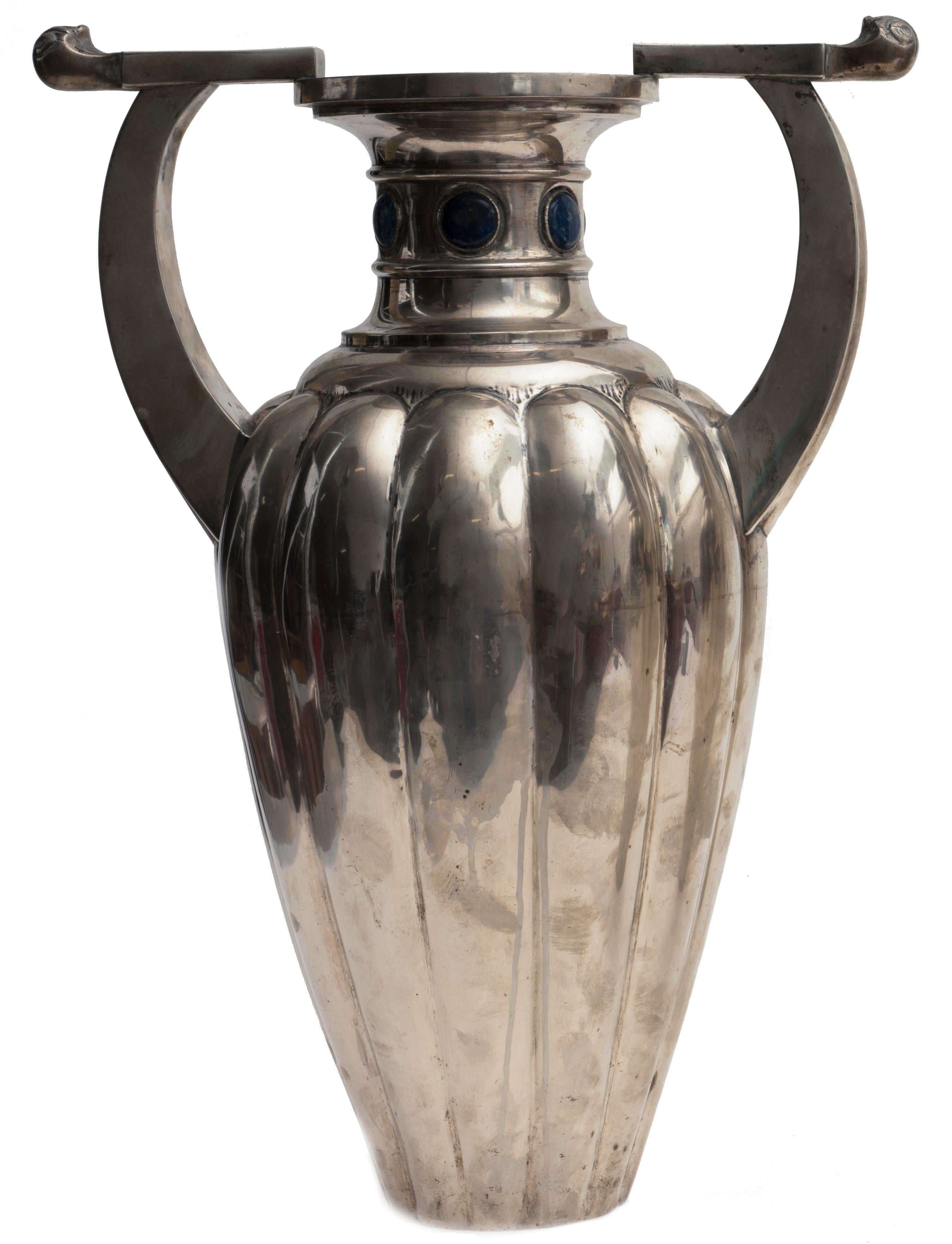 Pair of important two-handles vases in silver 800, body with wide flutings, neck with sodalite stones.
Signed on base “Bellotto” (important and historical venitian silver manufacturer).

Very good conditions.

This object is shipped from Italy.