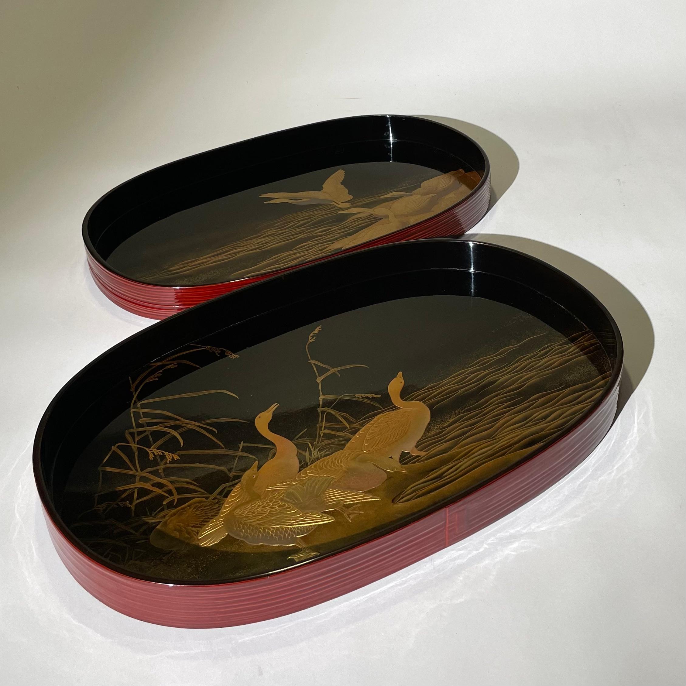 Japanese lacquer tray with the wild goose, reed, and wave design. This pair of tray is a fine example of multiple lacquer techniques using gold, hiramaki-e, takamaki-e, and togidashi. 

Wave and reed feature are expressed with the technique of