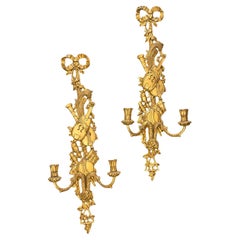 Pair of two-light gilded wood wall sconces in the Louis XVI style, 19th century