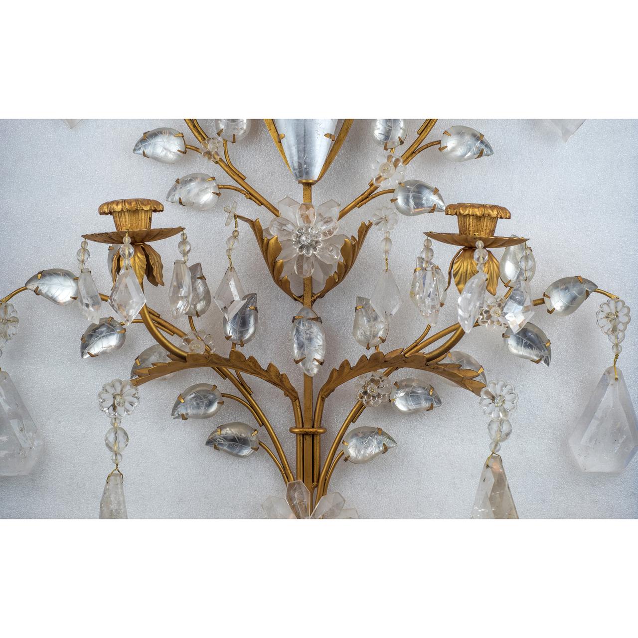 An elegant pair of two-light gilt bronze foliage, carved in rock crystal wall sconces.

Origin: French
Date: 20th century
Dimension: 33 in. x 21 1/2 in. x 5 in.