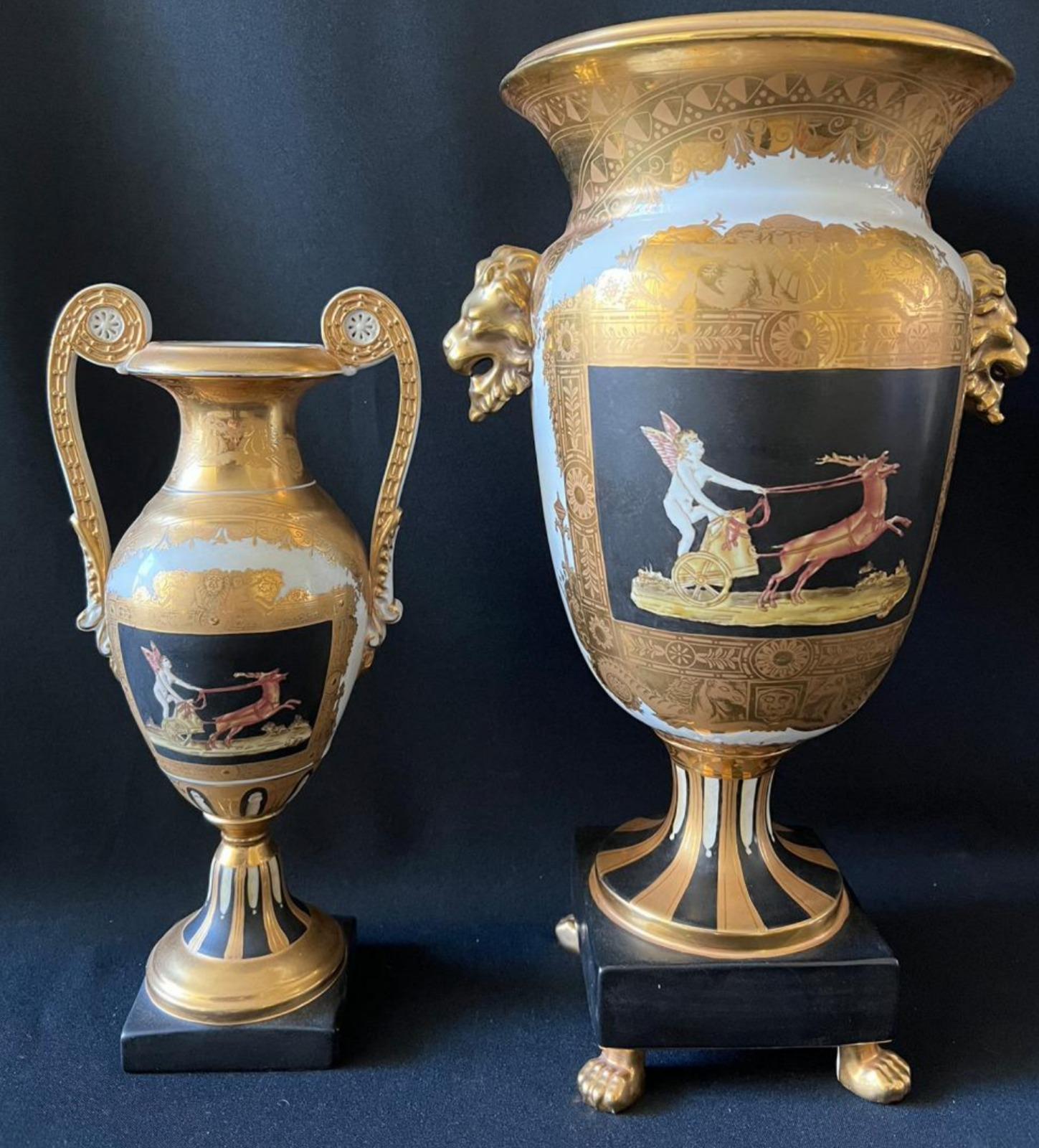 Pair of two magnificent vases in the shape of Greek Amphorae French Empire 19th century.

The large one on paw feet and with lion handles, the small one on a square stand with volute handles.
Porcelain, gilded and decorated with paintings, marked