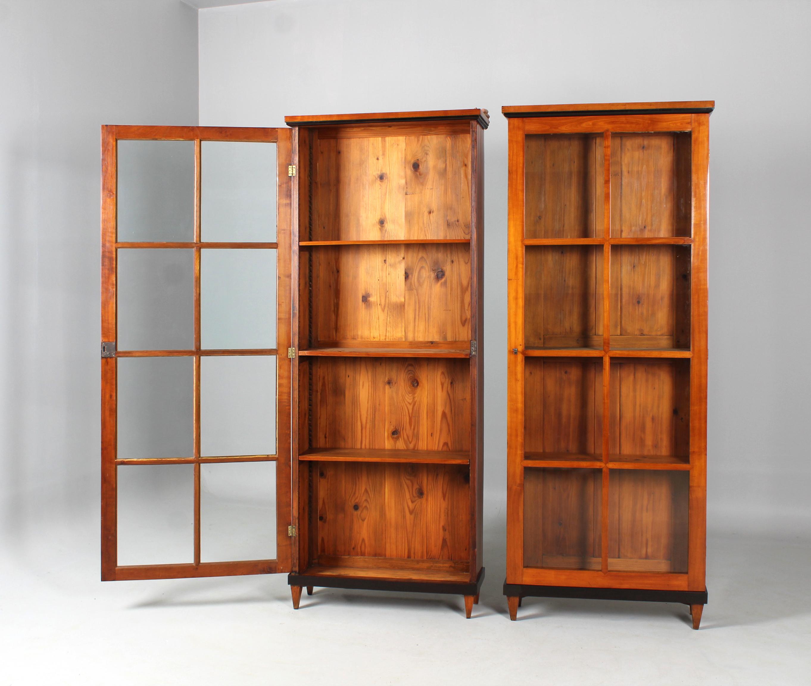 Two antique Biedermeier cherry bookcases

South Germany
Cherry tree
Biedermeier around 1820

Dimensions: H x W x D: 223 x 85 x 29 cm each

Description:
Beautiful and rare pair of two identical Biedermeier bookcases.

The strictly cubistic