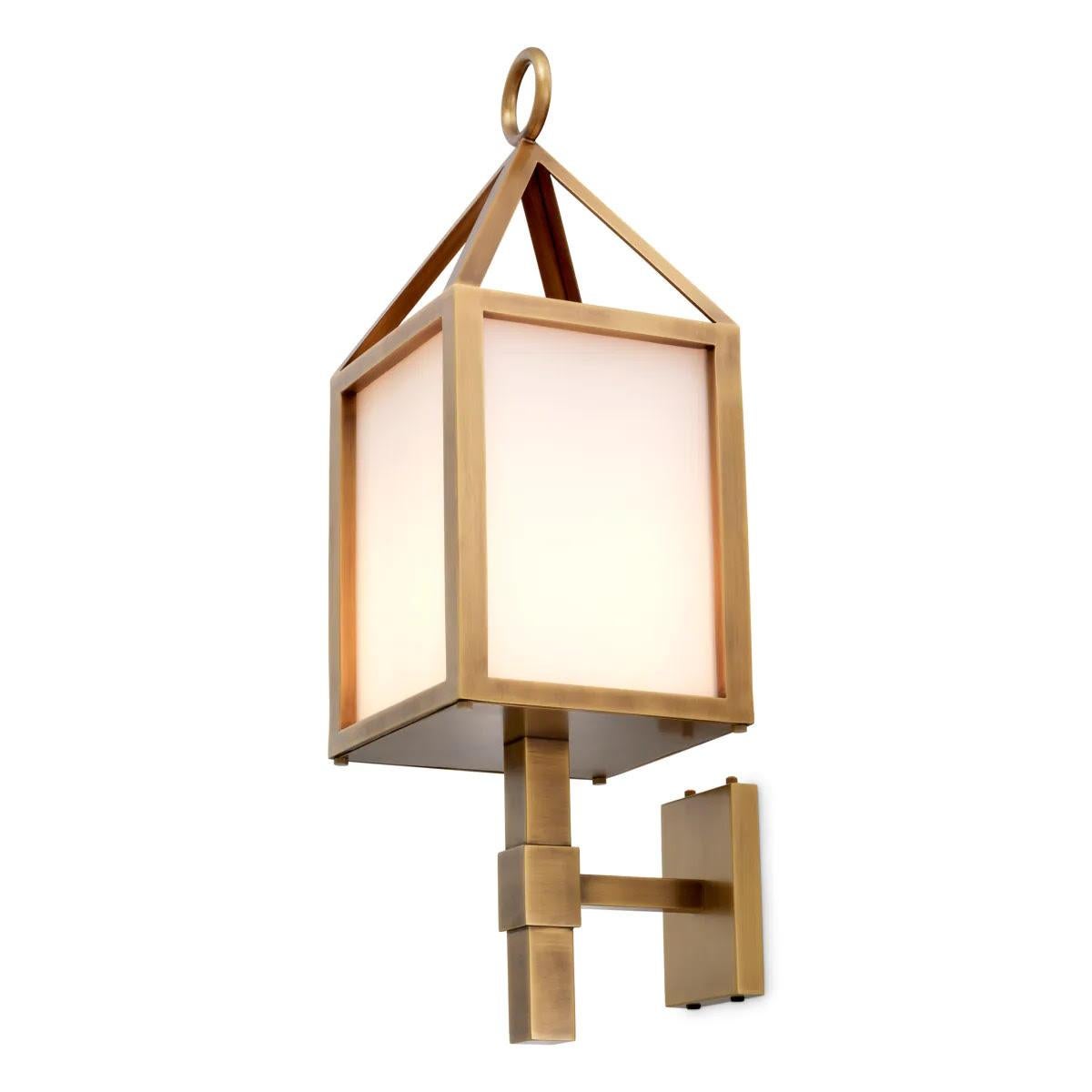 Pair of two outdoor wall lights, antique brass finish, white glass.

Enhance the ambiance of your outdoor space with this outdoor wall light.
Its antique brass finish and white glass combine timeless charm with contemporary style. Designed for