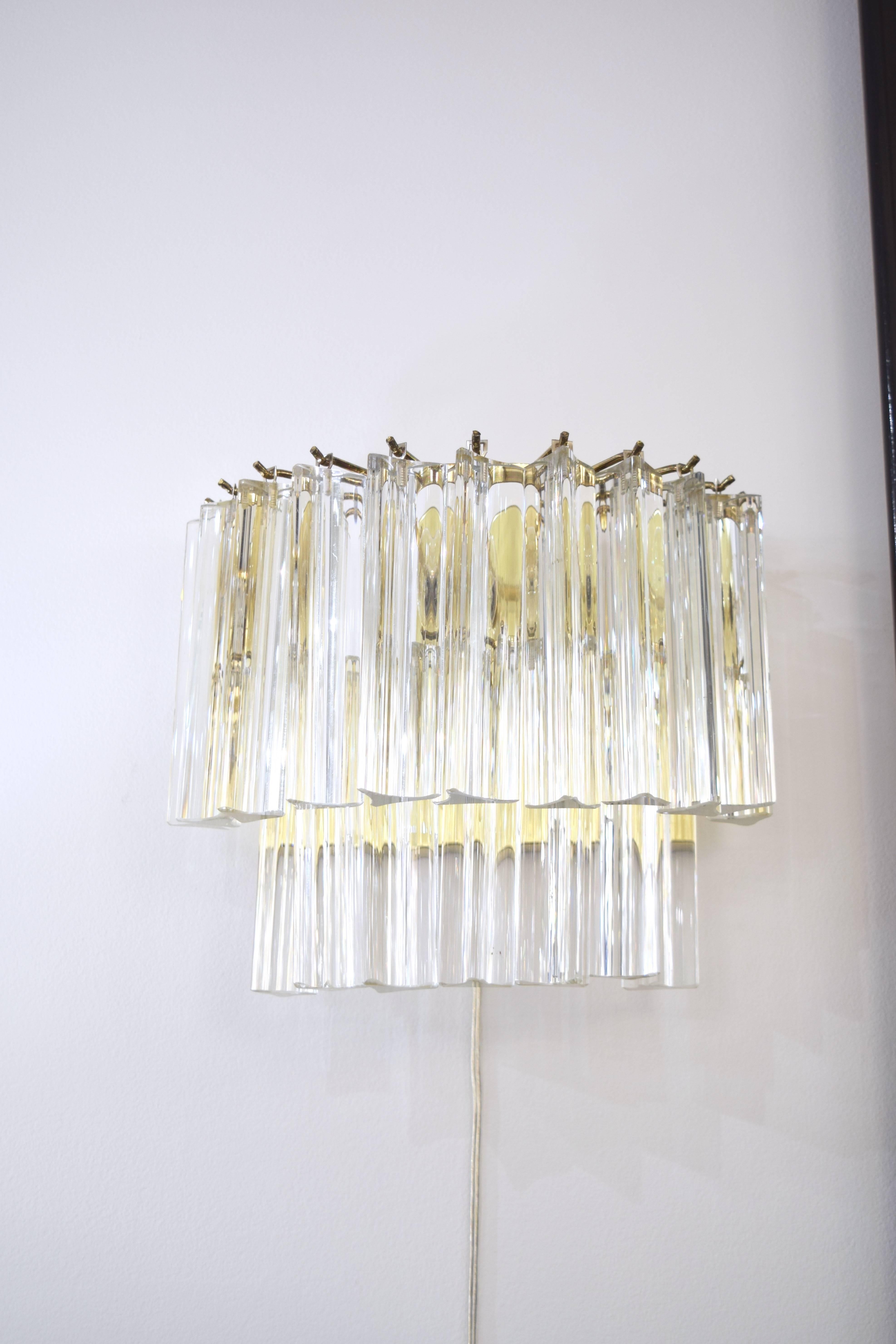 Pair of Italian sconces by Venini with two tiers of hanging glass prisms with a brass frame featuring three sockets.
