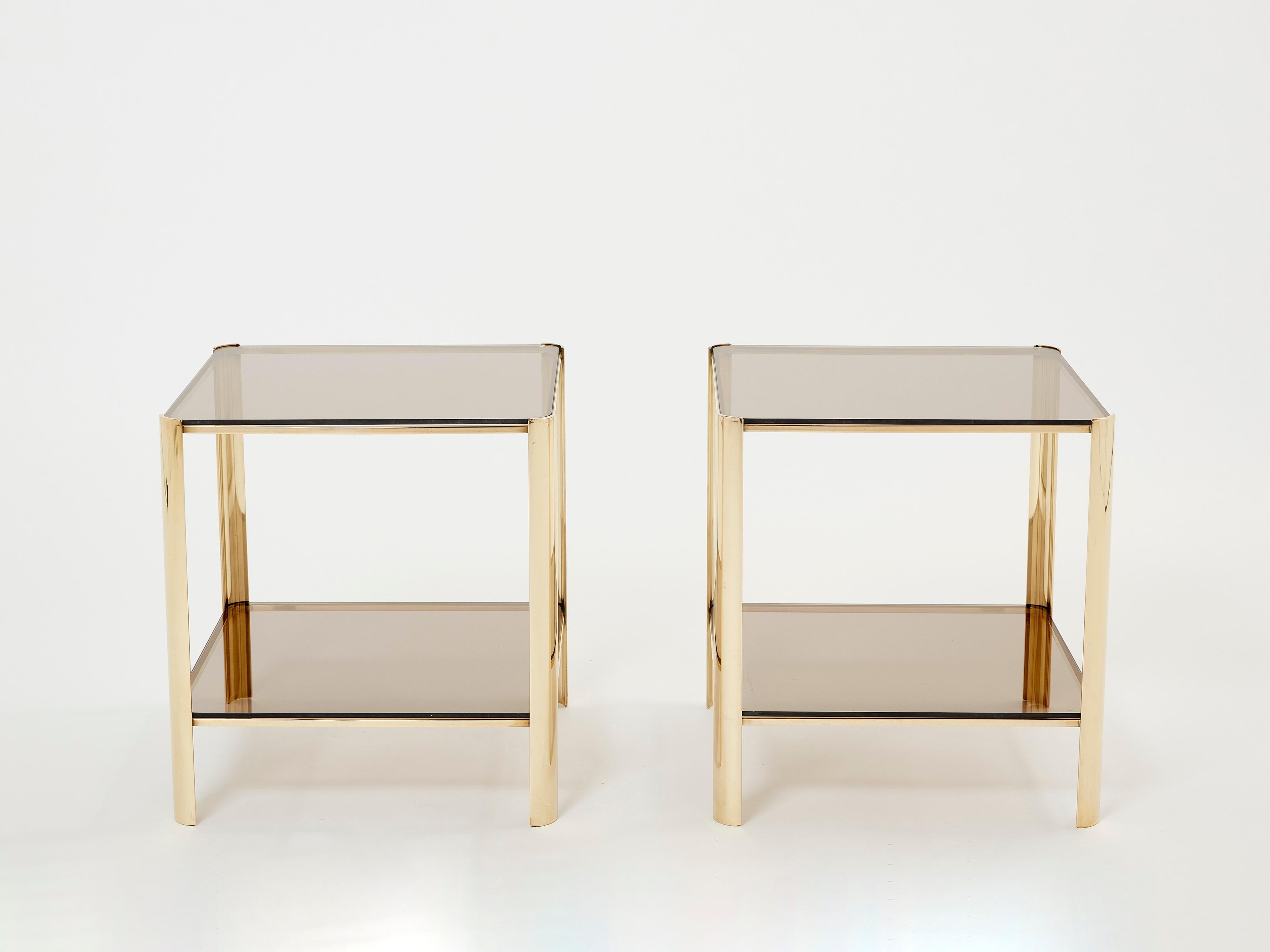 This beautiful pair of two-tier side tables signed by Jacques Quinet and stamped by Broncz, is a remarkable find. They feature a strong, solid bronze structure built to last forever. The original two-tier smoky glass tops add a nice aesthetic appeal