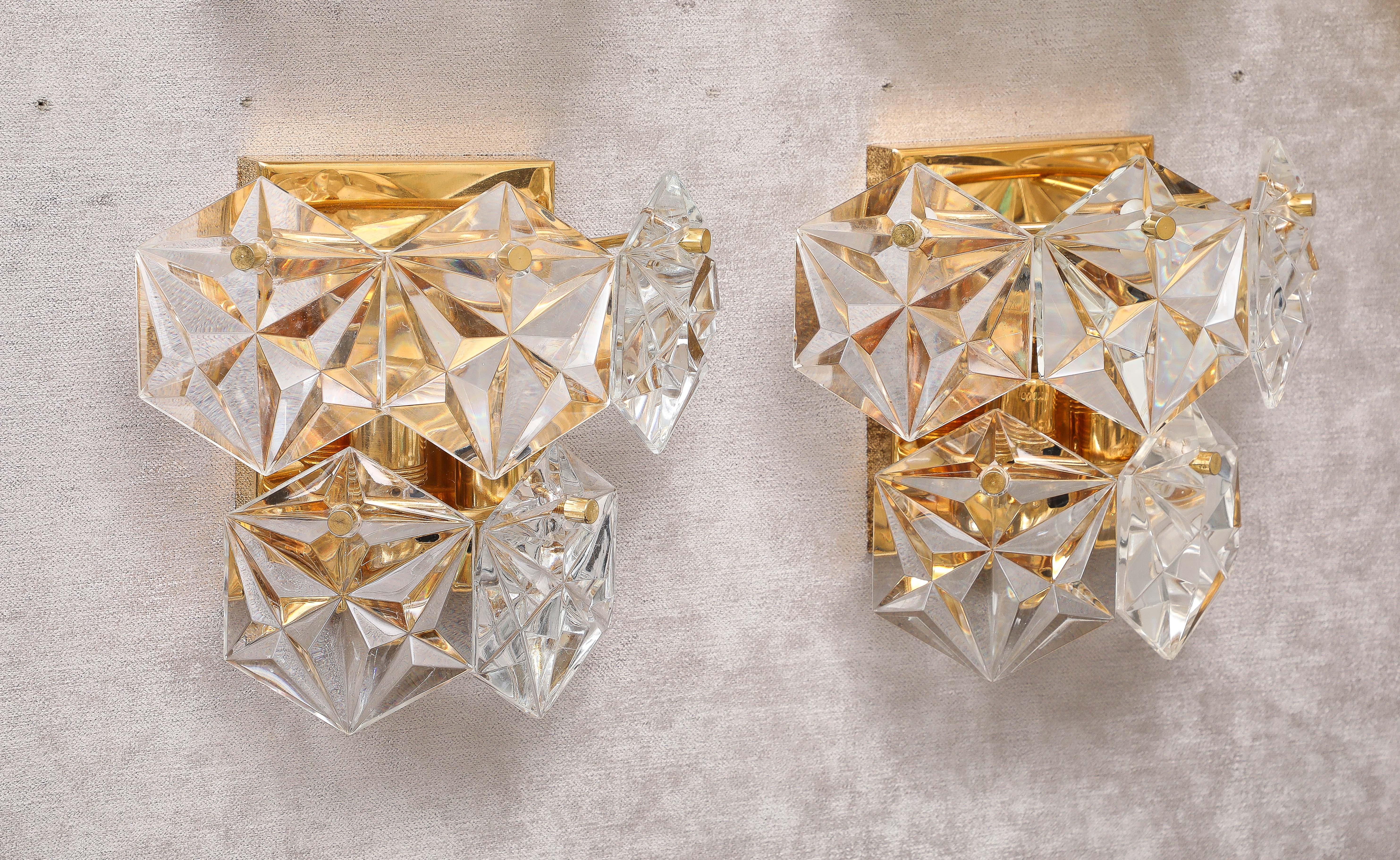Glamorous pair of 1960's Hexagonal faceted crystal sconces by Kinkeldey.
The 22-karat gold back plates each hold 5 crystal prisms with are illuminated by
 two light sources.
40 Watts per socket / 80 watts per fixture.