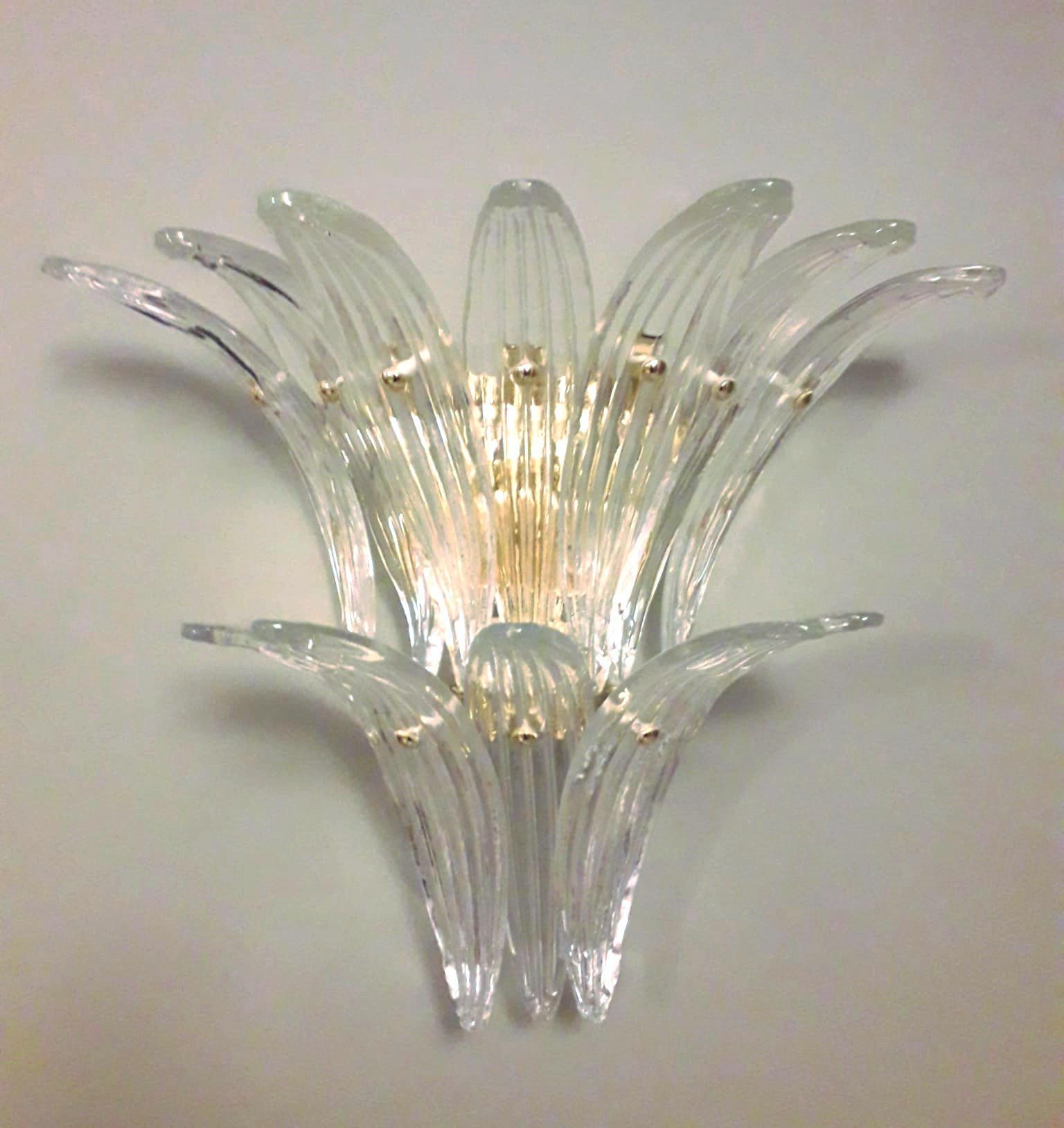 Italian wall light with vintage clear Murano palmette glass leaves mounted on newly made gold finish metal frames / Made in Italy.
Measures: height 16 inches, width 18 inches, depth 9 inches.
2 Lights / E12 or E14 type / max 40W each.
2 Pairs