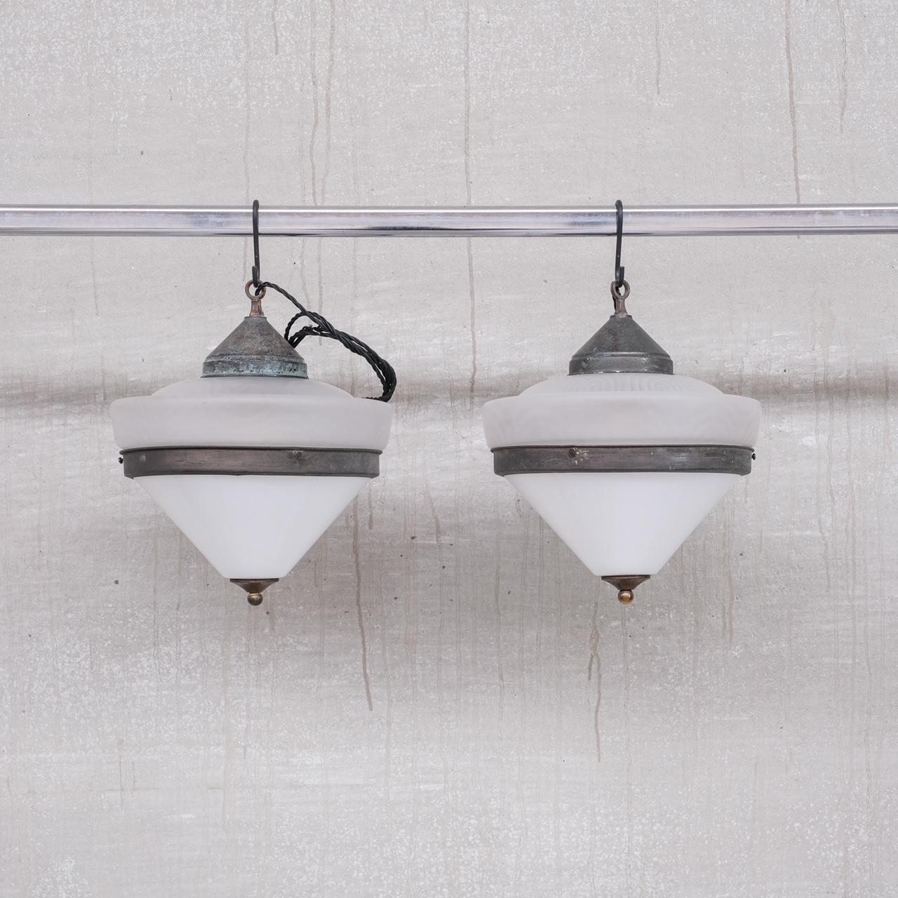 A pair of antique pendant lights of remarkable quality. 

France, circa 1920s. 

Unique swirly style glass to the top, opaline conical glass to the base. 

Some of the best lights we have sourced. 

PRICE IS FOR THE PAIR. 

Re-wired and