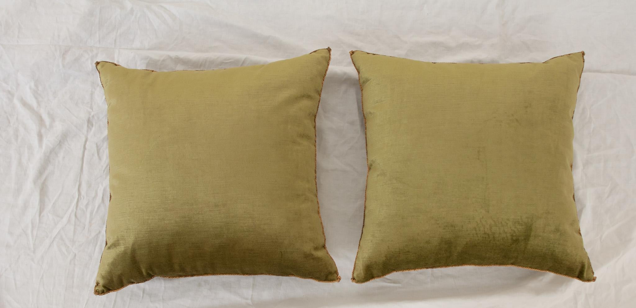 A pair of beautiful two-tone velvet pillows. Hand trimmed and features vintage gold metallic cording, knotted in the corners. Designed by Rebecca Vizard for B. Viz Design. Sold as a pair only. Be sure to take a look at the detailed images to see the