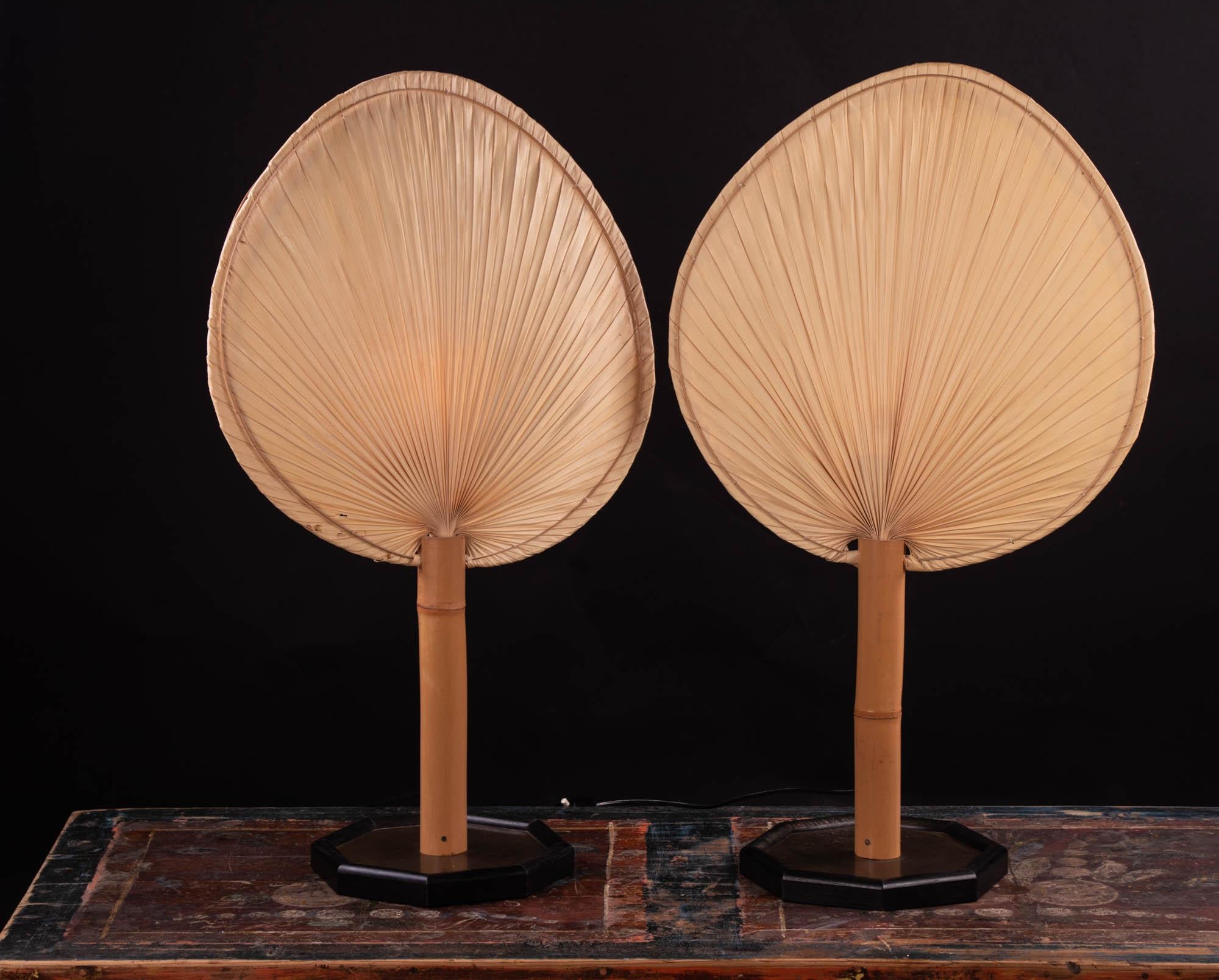 Pair of fan table lights by Ingo Maurer Design M, Germany, 1970s from the Uchiwa series. 
Fan made of bamboo and Japanese rice paper, the Stand is made of metal and wood. One E14 Edison base bulb. 

The lamp has been tested with US American light