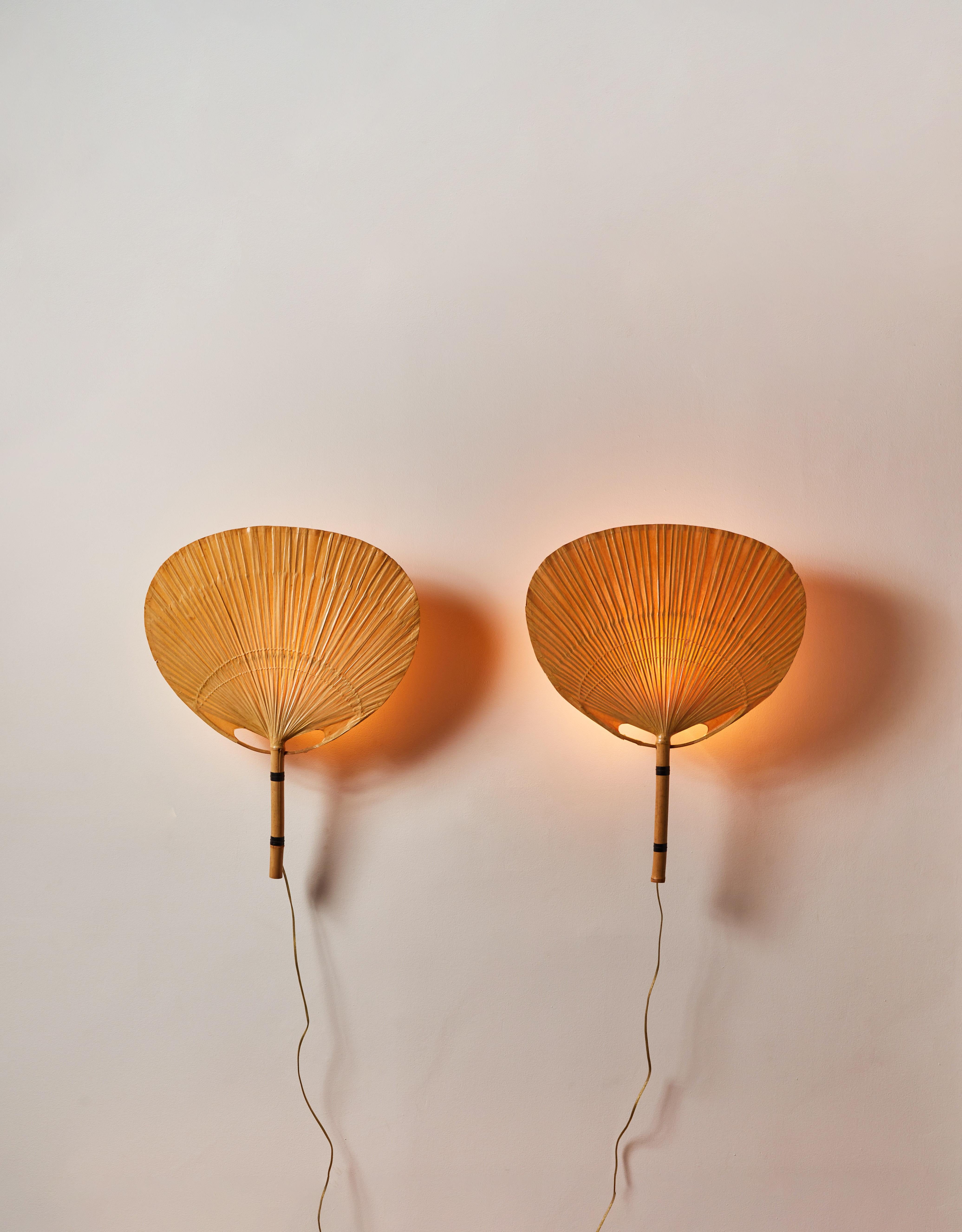 Pair of Uchiwa Sconces by Ingo Maurer. Designed and manufactured in Germany, circa 1970s. Bamboo, rice paper. Rewired for U.S. Standards. Each light takes one E27 40w maximum bulb. Bulbs provided as a one time courtesy.