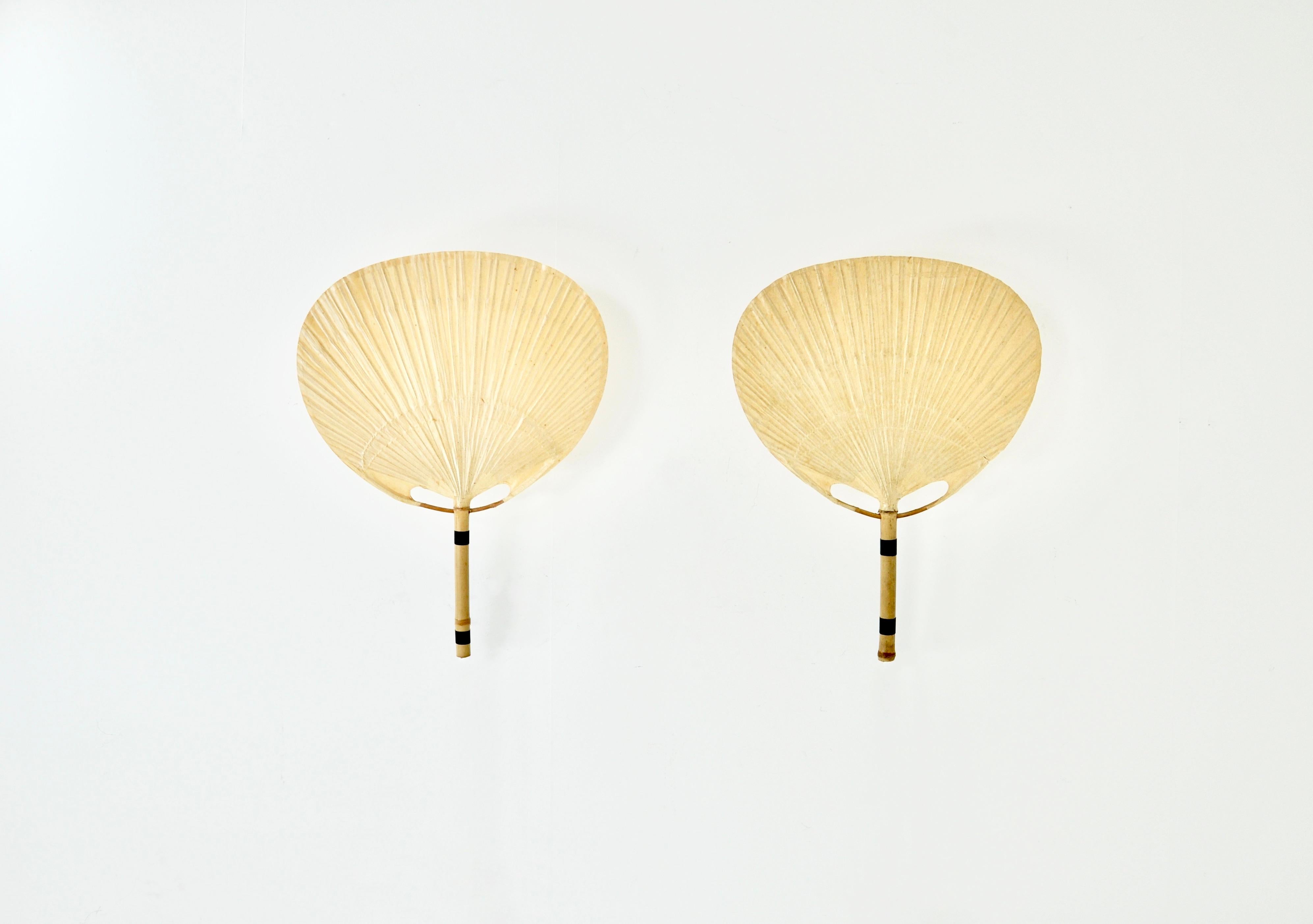 Pair of sconces en bamboo and paper mounted on a metal bracket. Wear on one of the sconces .