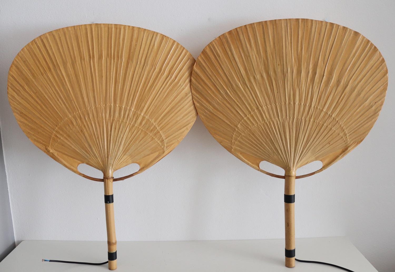Two pieces of big vintage Uchiwa fan lamps with metal holder for wall hanging.
Designed from Ingo Maurer, Germany in 1973. One light is equipped with original label 