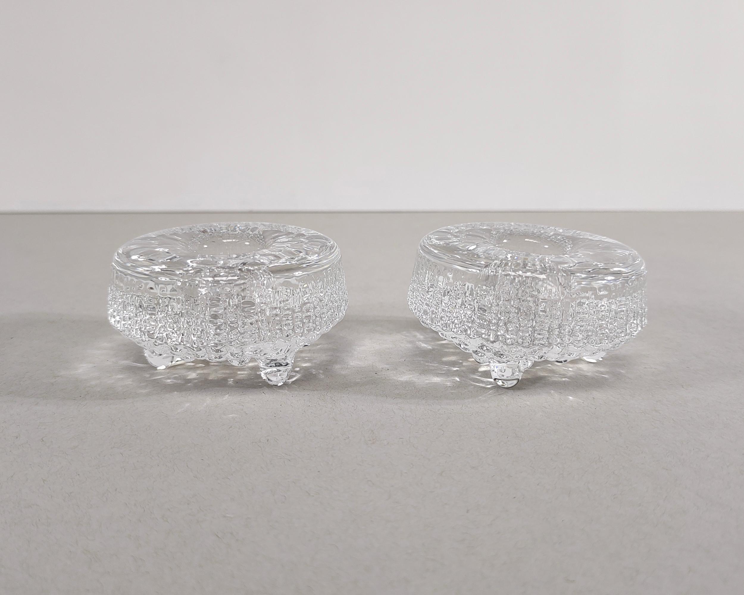 Set of two solid glass candlestick holders from the 'Ultima Thule' collection by iconic Finnish designer, Tapio Wirkkala. Classic icy drip detail that Wirkkala is known for. Excellent vintage condition.

2-5/8