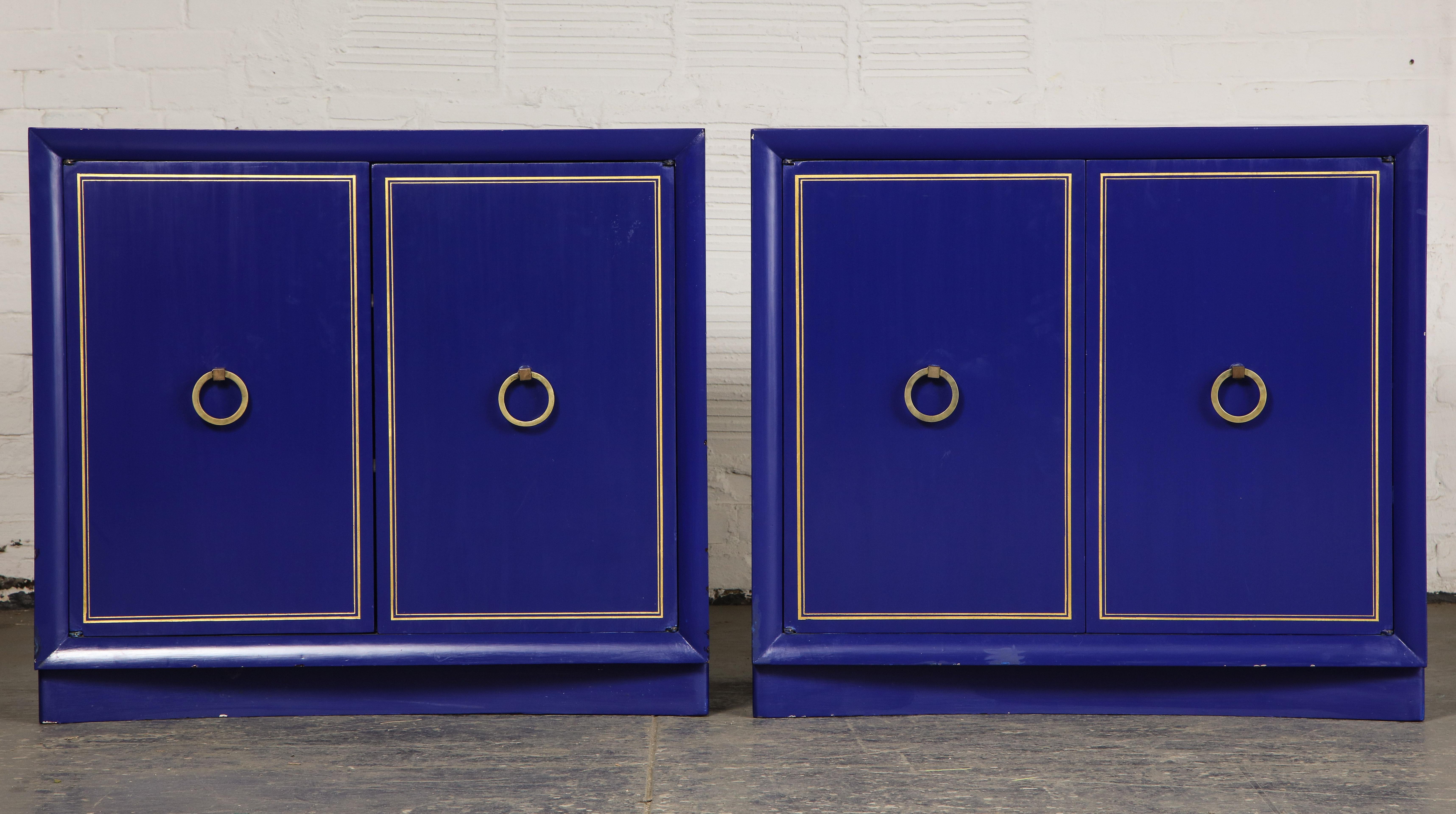 Each fitted with two-cabinet doors with gilt banding opening to two shelves.