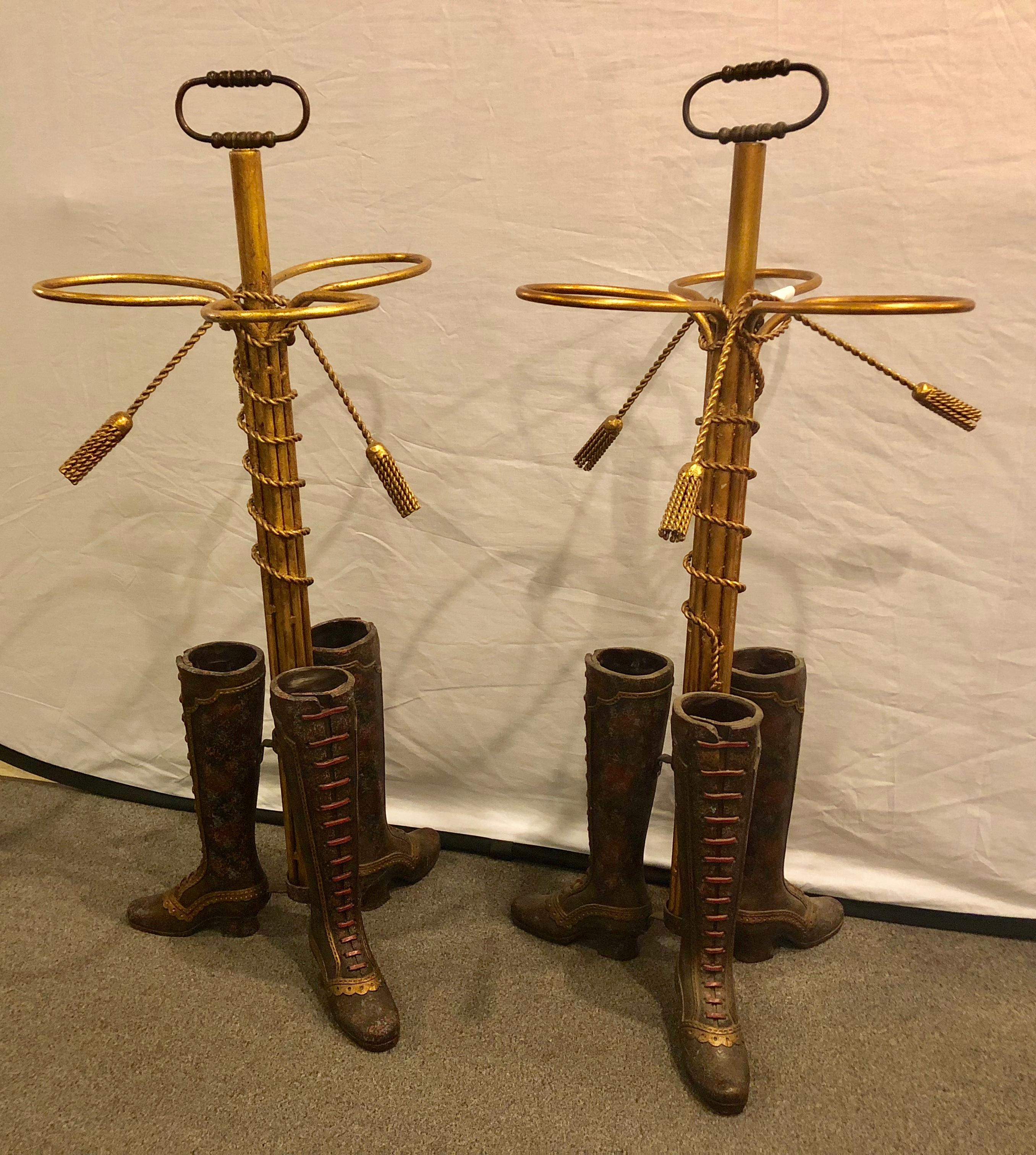 A pair of umbrella stands each depicting painted boots on bronze from base. Priced by the piece. 
