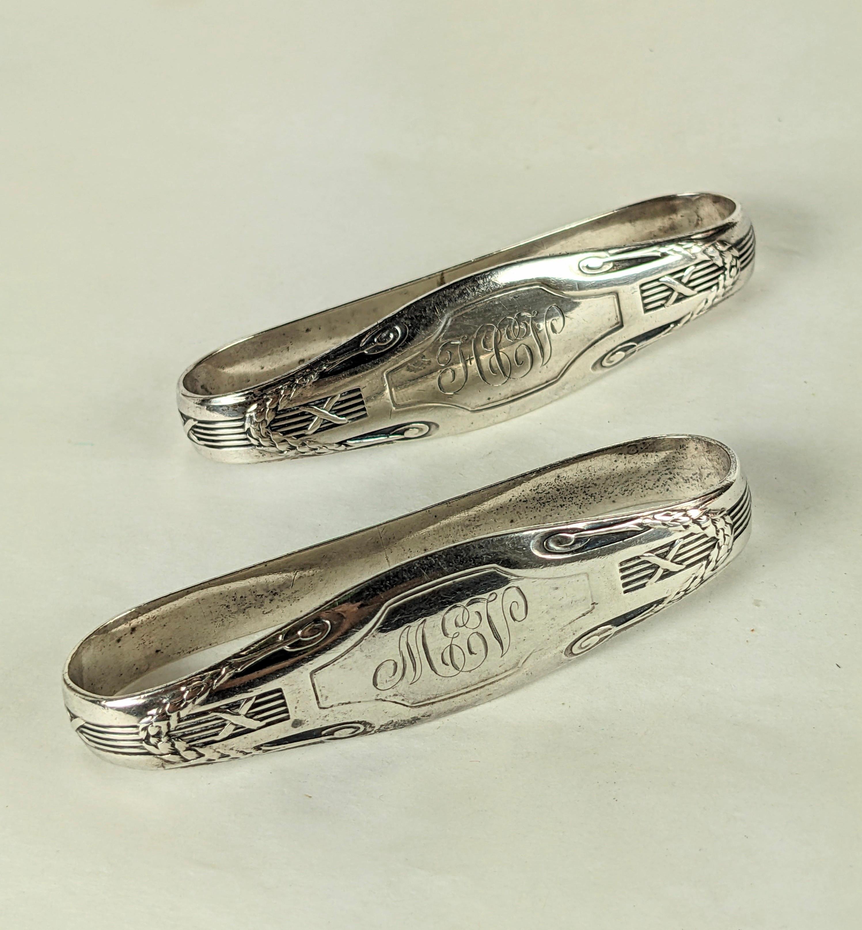 Pair of large Unger Brothers Edwardian Napkin Holders with reed and wreath designs. Heavy sterling, each with triple period monograms. Priced for the pair. 
1920's USA. Signed Unger Bros. 