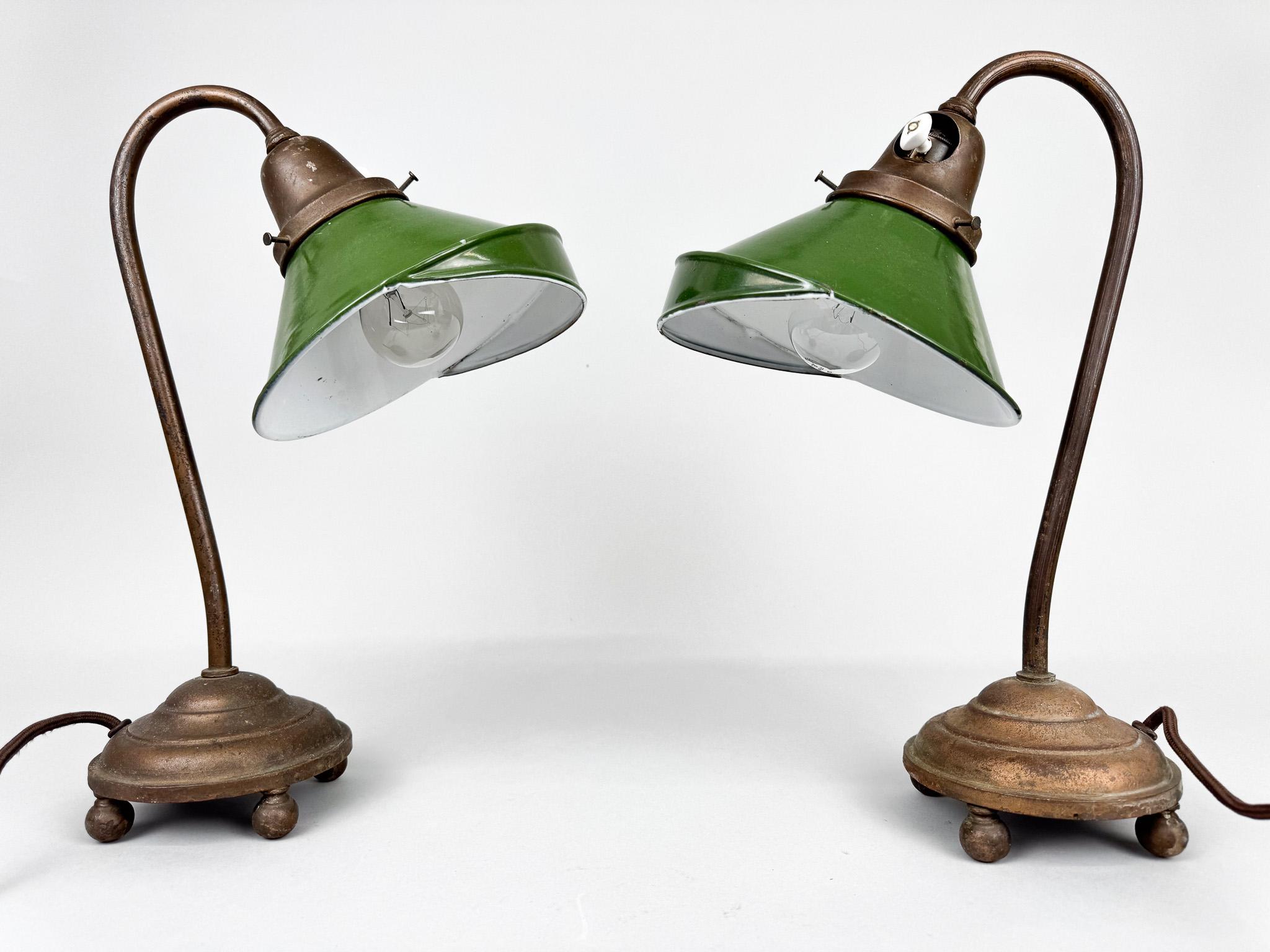 Set of two rare cast iron and enamelled metal desk lamps. Made in former Czechoslovakia in the 1920's. 
Rewired. 
Bulb: 2 x 1 E27 (E26). US adapter included.