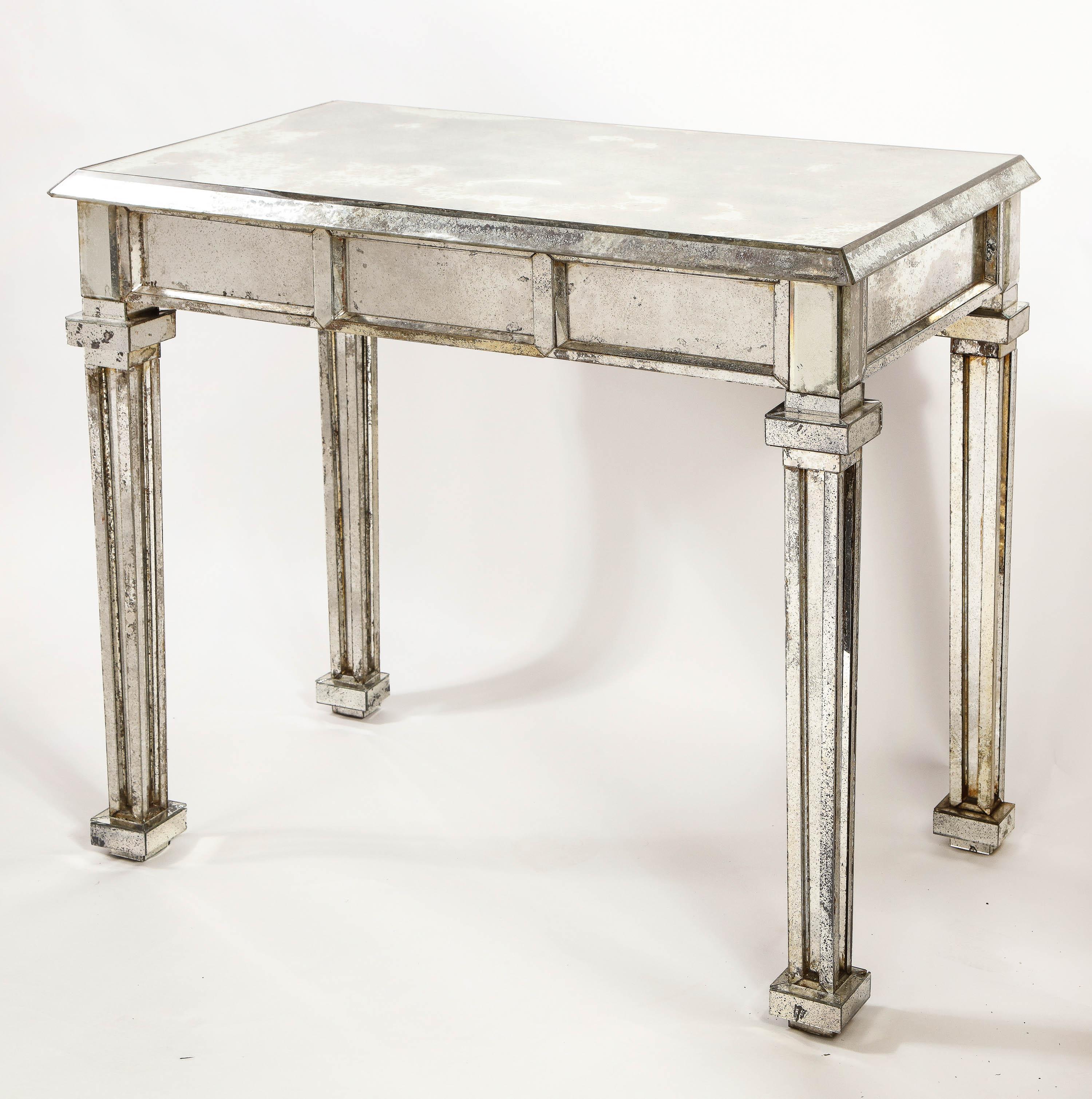 A pair of unusual antique French Art Deco rectangular form distressed mirrored console or side tables of exquisite craftsmanship and detail.