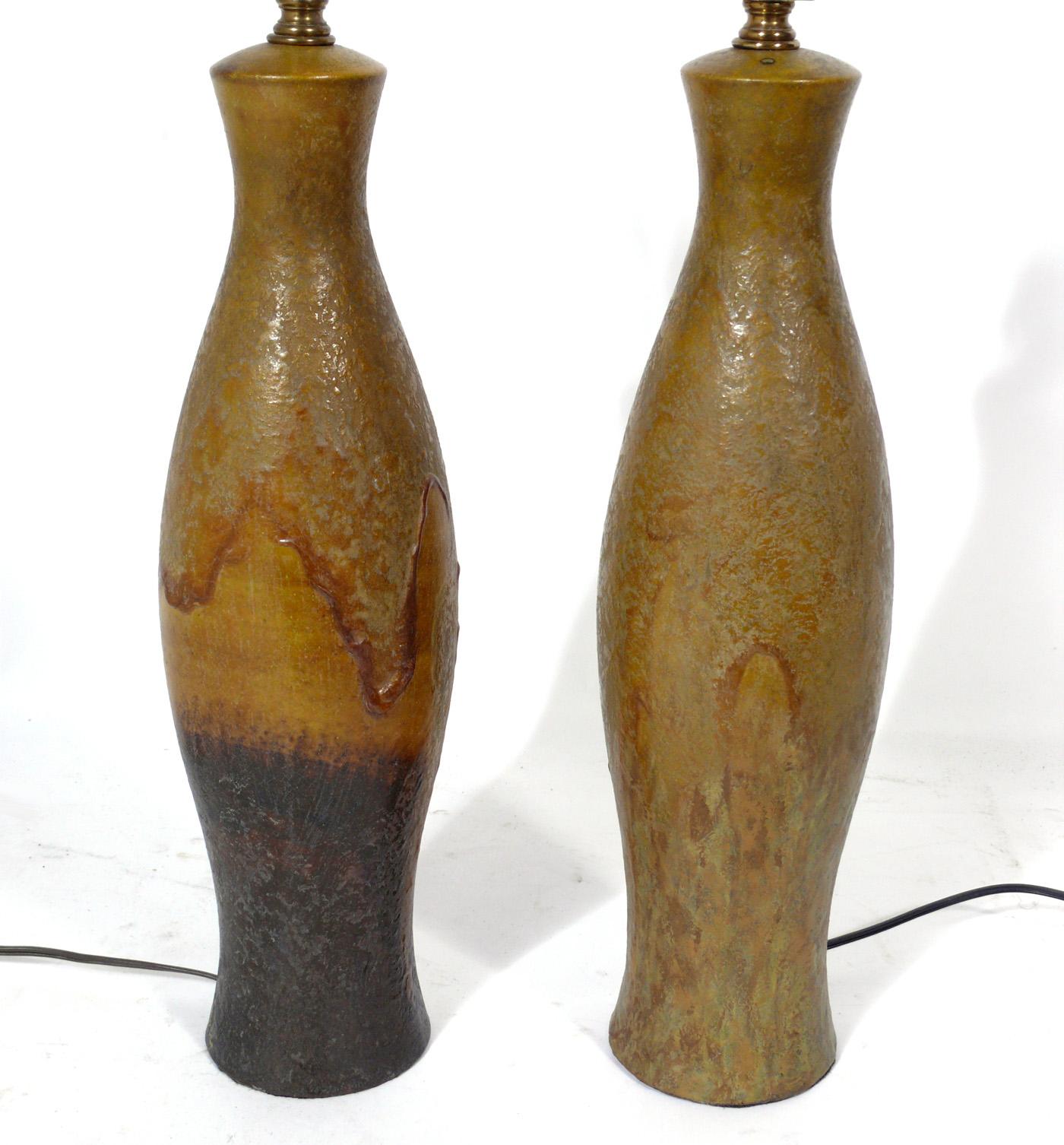 Pair of unique ceramic lamps by Marcello Fantoni, Italy, circa 1950s. Hand signed. Large scale sculptural forms, each uniquely hand painted, then glazed by the artist. The priced noted below includes the shades. They have been rewired and are ready