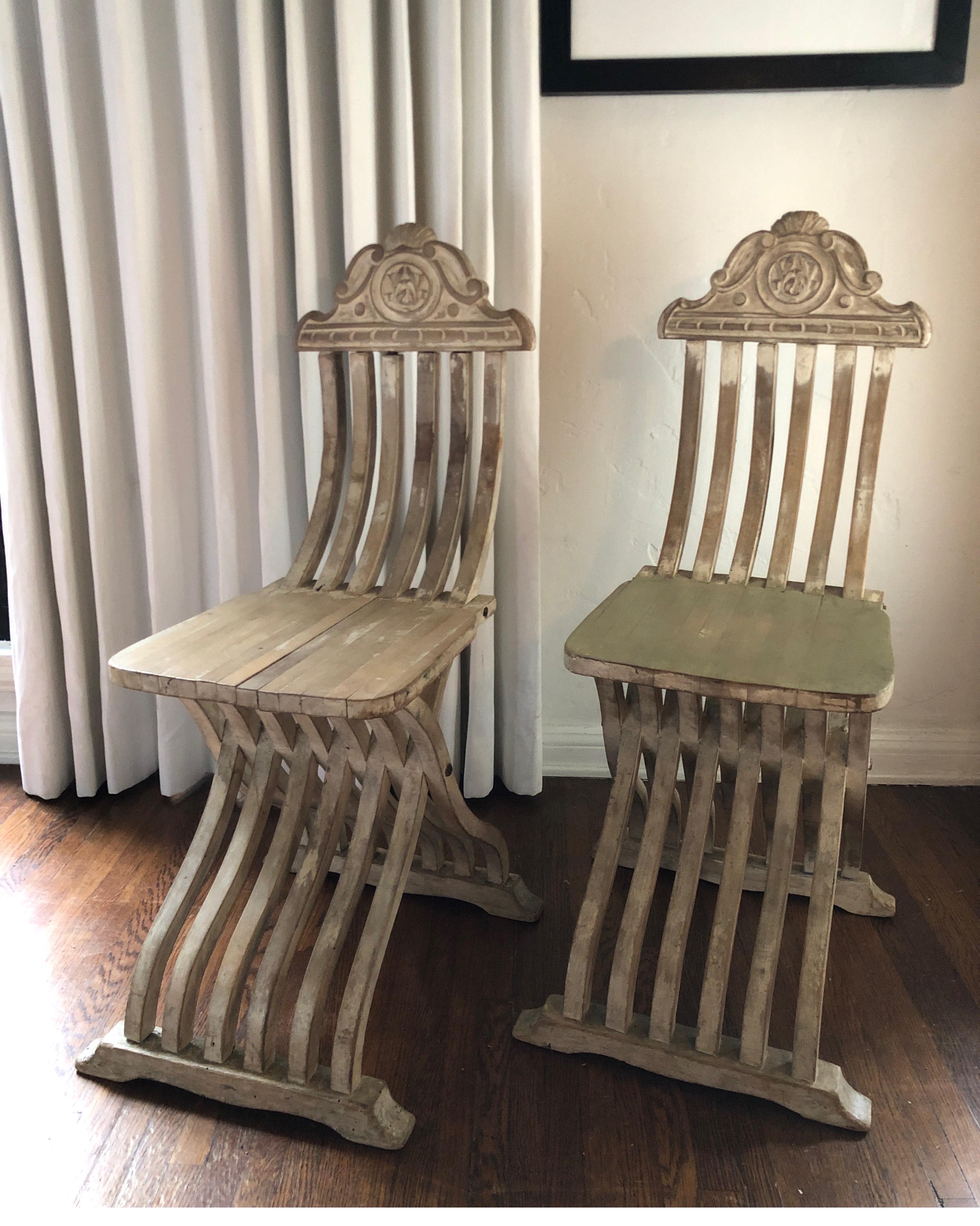 Pair of unique carved wood Savonarola side chairs for a entry way, dining table, slipper chairs.
Very sturdy. 
Ornate Italian carving at the top.