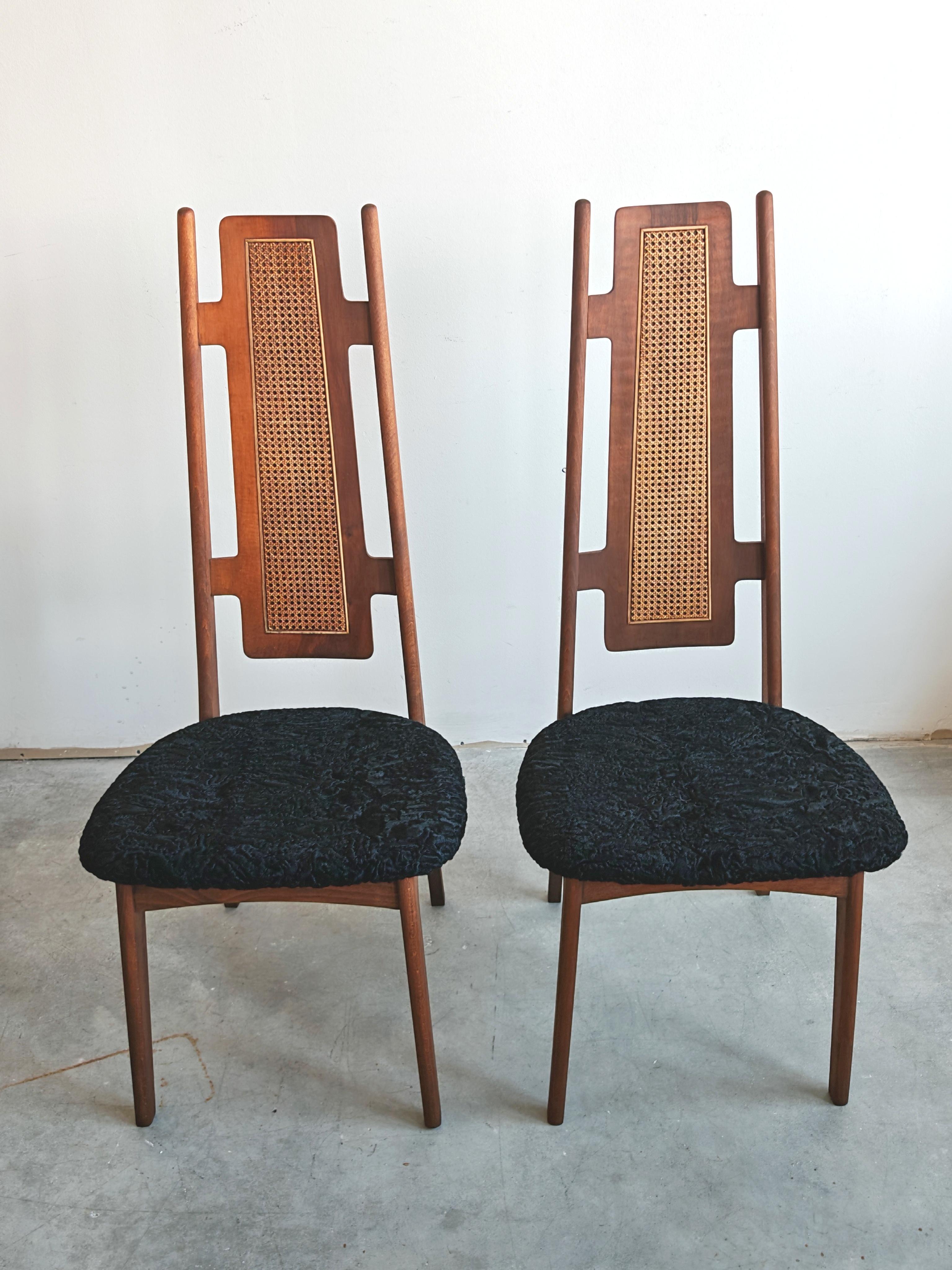 In this listing you will find a pair of striking Mid Century Modern Side or Accent chairs with high backrests. The chairs are made in beech, backrest in walnut and cane, while the seats have been upholstered in Astrakhan fur. The chairs were made in