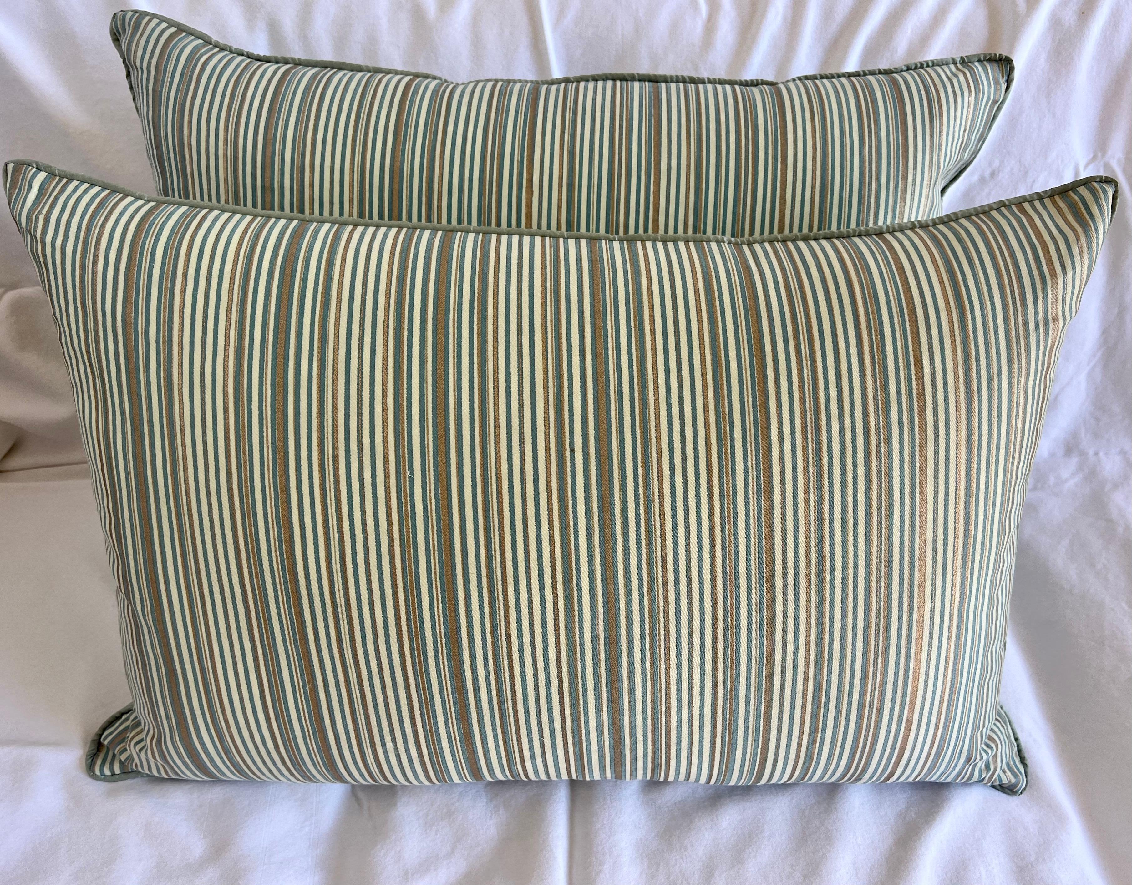 Pair of Custom pillows made with printed stripe Fortuny Textile fronts and silk backs. Self cording. Zipper closures.