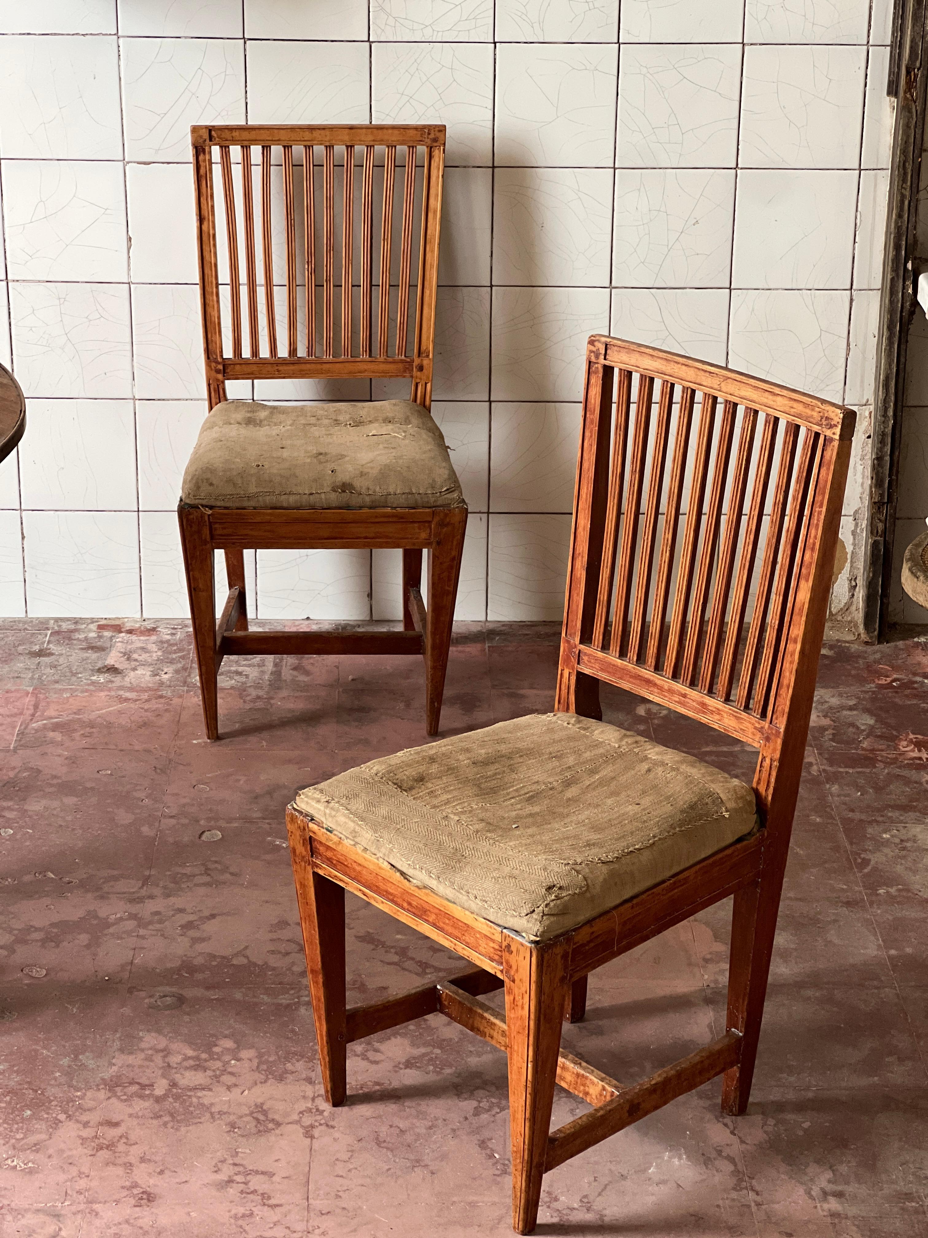 Unique Swedish wooden chairs made of massive wood around the end of the 1700 (1780/90). Lots of history, patina and traces of time. Very good condition.  The seatings are made of old linen that was repaired and stitched during her lifetime. Hard to