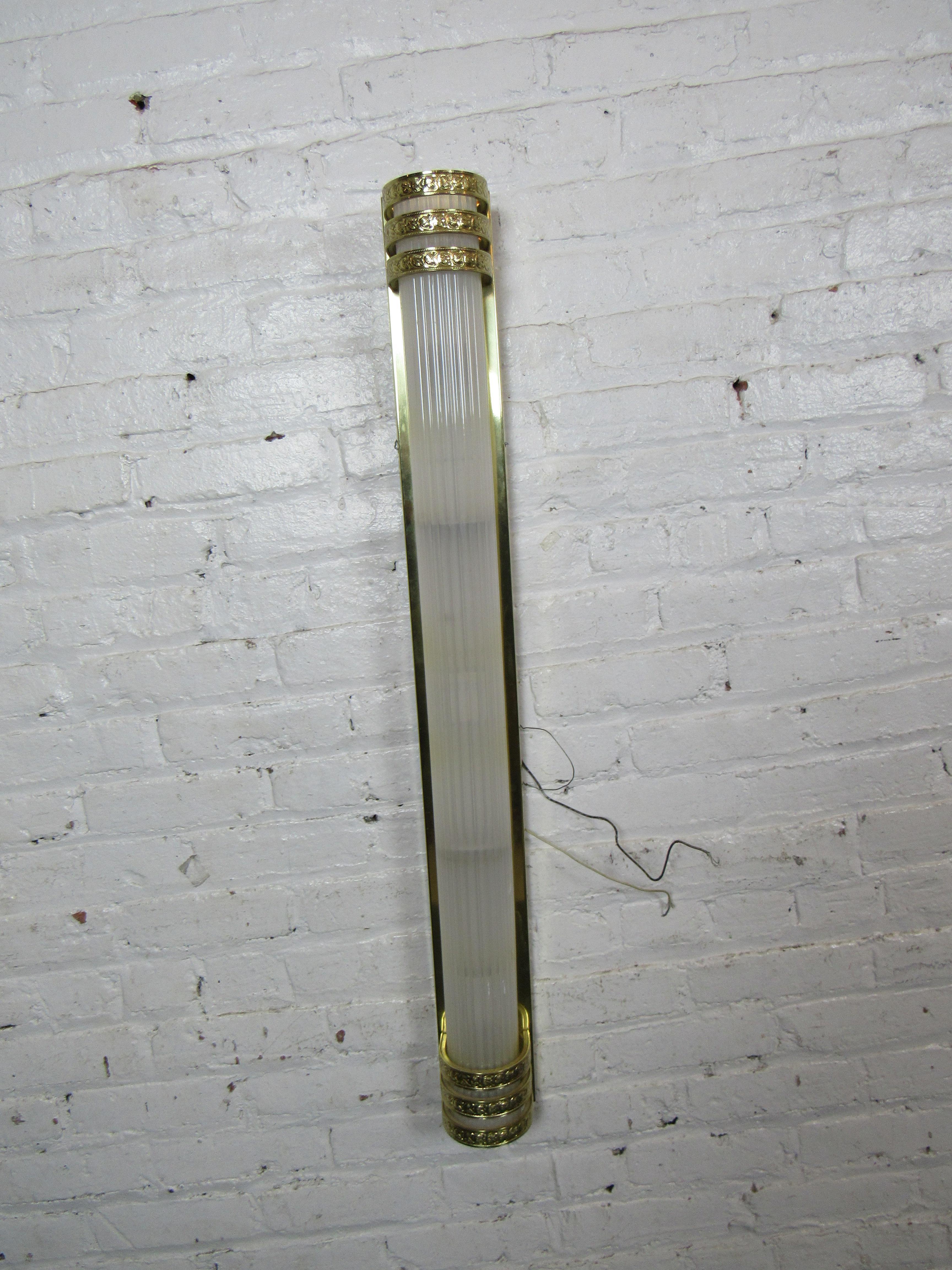 With a unique cylindrical lucite cover, these wall mounted light fixtures offer a stylish way to light any interior. Please confirm item location with seller (NY/NJ).